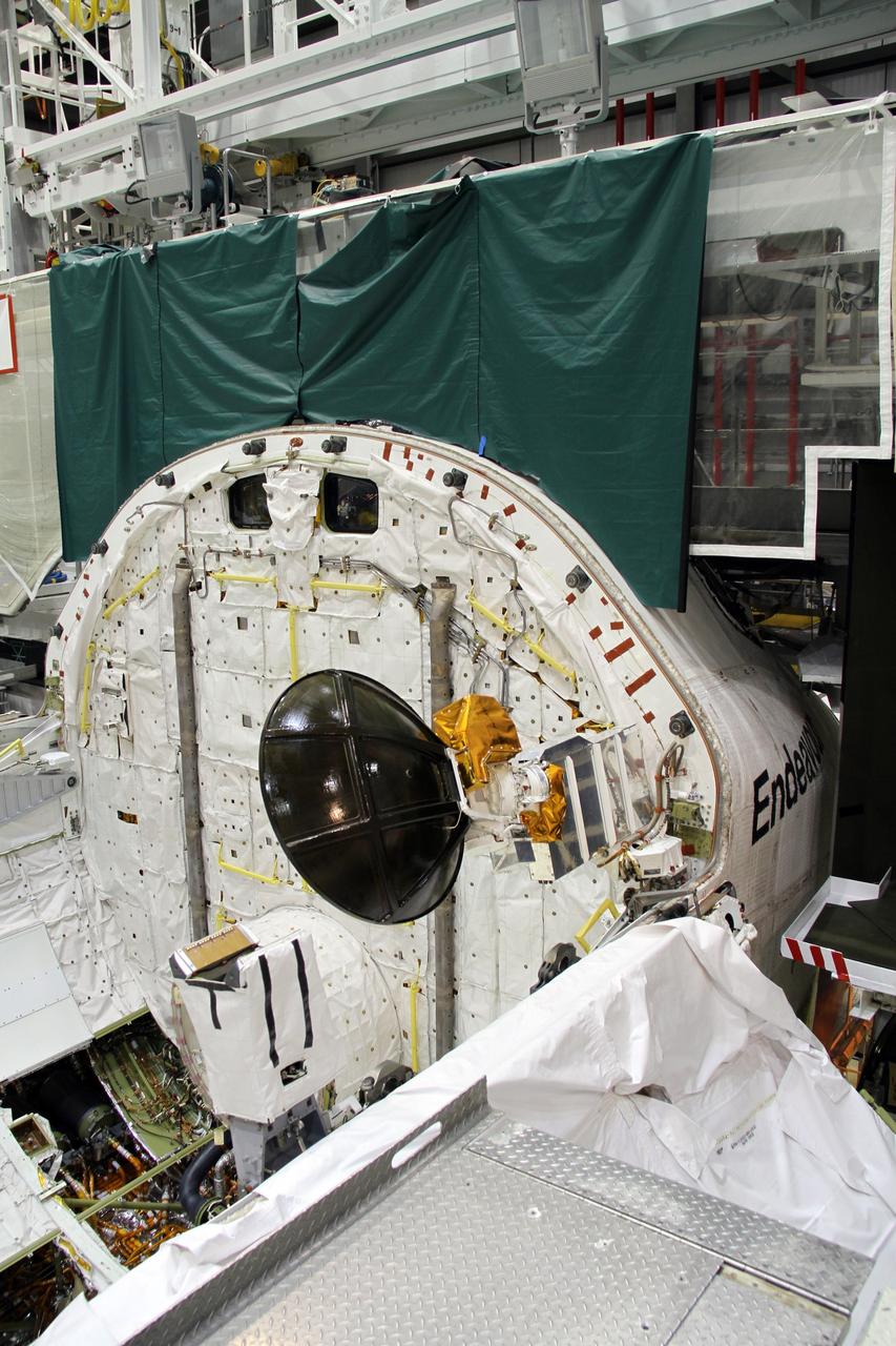 CAPE CANAVERAL, Fla. – In Orbiter Processing Facility-2 at NASA's Kennedy Space Center in Florida, stowage of a Ku-band antenna in space shuttle Endeavour’s payload bay is under way in preparation for final closure of the shuttle’s payload bay doors. The antenna, which resembles a mini-satellite dish, was used to transmit audio, video and data between the shuttle and ground stations on Earth. Endeavour is being prepared for public display at the California Science Center in Los Angeles. Its ferry flight to California is targeted for mid-September. Endeavour was the last space shuttle added to NASA’s orbiter fleet. Over the course of its 19-year career, Endeavour spent 299 days in space during 25 missions. For more information, visit http://www.nasa.gov/transition. Photo credit: NASA/Cory Huston