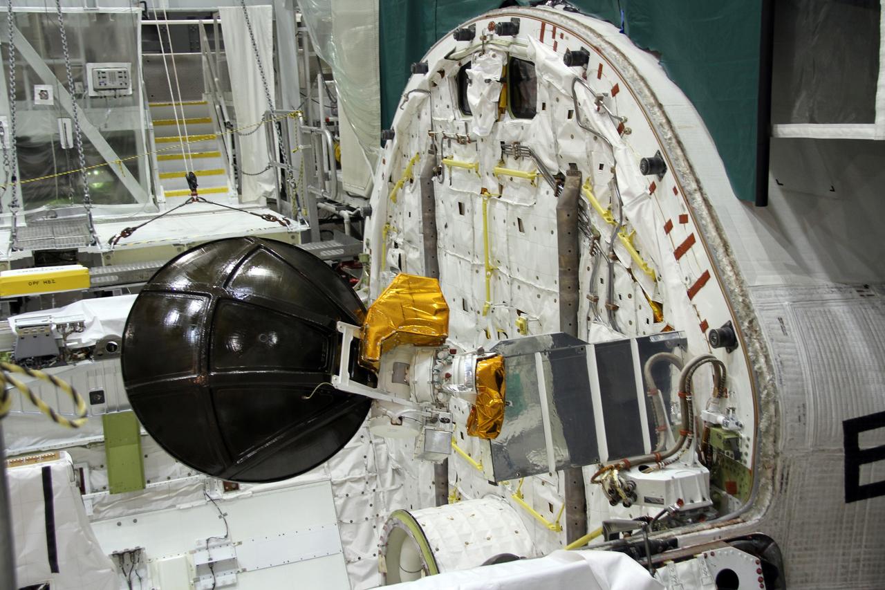 CAPE CANAVERAL, Fla. – In Orbiter Processing Facility-2 at NASA's Kennedy Space Center in Florida, a Ku-band antenna is stowed in space shuttle Endeavour’s payload bay in preparation for final closure of the shuttle’s payload bay doors. The antenna, which resembles a mini-satellite dish, was used to transmit audio, video and data between the shuttle and ground stations on Earth. Endeavour is being prepared for public display at the California Science Center in Los Angeles. Its ferry flight to California is targeted for mid-September. Endeavour was the last space shuttle added to NASA’s orbiter fleet. Over the course of its 19-year career, Endeavour spent 299 days in space during 25 missions. For more information, visit http://www.nasa.gov/transition. Photo credit: NASA/Cory Huston