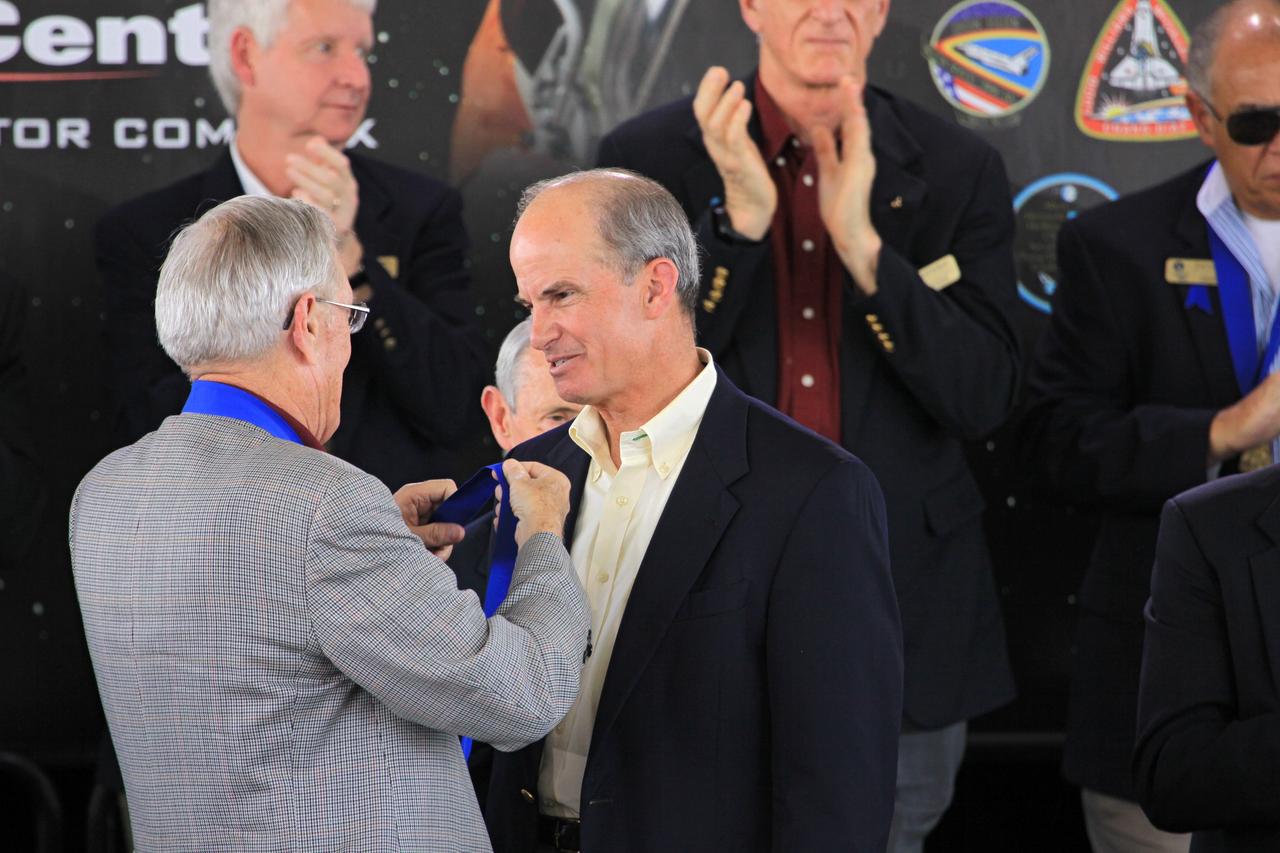 CAPE CANAVERAL, Fla. – At NASA’s Kennedy Space Center Visitor Complex in Florida, Astronaut Scholarship Foundation Chairman and Hall of Fame astronaut Charlie Duke inducts shuttle astronaut Kevin Chilton into the U.S. Astronaut Hall of Fame Class of 2012 during the induction ceremony. Shuttle astronauts Franklin Chang Diaz and Charlie Precourt also were inducted into the Hall of Fame.    The year’s inductees were selected by a committee of current Hall of Fame astronauts, former NASA officials, historians and journalists. The selection process is administered by the Astronaut Scholarship Foundation. Photo credit: NASA/Jim Grossmann