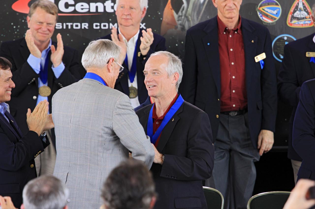 CAPE CANAVERAL, Fla. – At NASA’s Kennedy Space Center Visitor Complex in Florida, Astronaut Scholarship Foundation Chairman and Hall of Fame astronaut Charlie Duke inducts shuttle astronaut Charlie Precourt into the U.S. Astronaut Hall of Fame Class of 2012 during the induction ceremony. Shuttle astronauts Franklin Chang Diaz and Kevin Chilton also were inducted into the Hall of Fame.    The year’s inductees were selected by a committee of current Hall of Fame astronauts, former NASA officials, historians and journalists. The selection process is administered by the Astronaut Scholarship Foundation. Photo credit: NASA/Jim Grossmann