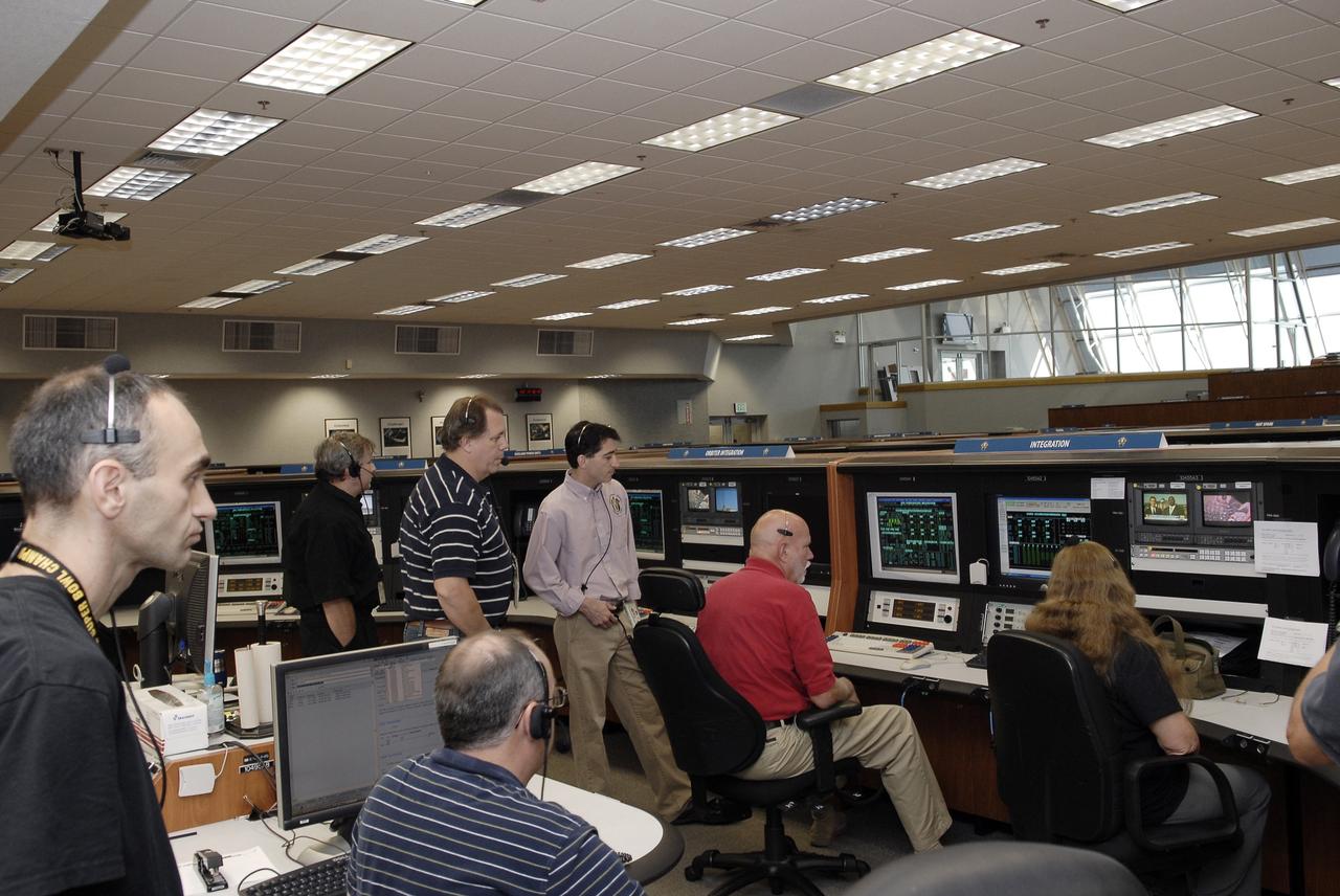 CAPE CANAVERAL, Fla. – NASA and contractor engineers are on hand at the Firing Room 4 Integration Console as operations to power down space shuttle Endeavour for the final time are under way in Orbiter Processing Facility-2 at NASA’s Kennedy Space Center in Florida. Standing, from left, are Alex Pandelos of QinetiQ North America and John Apfelbaum, Bob Walker and Michael Ciannilli of NASA. Seated, from left, are John McClellan and former test project engineer Greg Koch of United Space Alliance and Debbie Awtonomow of NASA. The Integration Console manages all orbiter systems including those needed for shuttle power up and launch.    Endeavour is being prepared for public display at the California Science Center in Los Angeles. Its ferry flight to California is targeted for mid-September. Endeavour was the last space shuttle added to NASA’s orbiter fleet. Over the course of its 19-year career, Endeavour spent 299 days in space during 25 missions. For more information, visit http://www.nasa.gov/transition.  Photo credit: NASA/Tim Jacobs