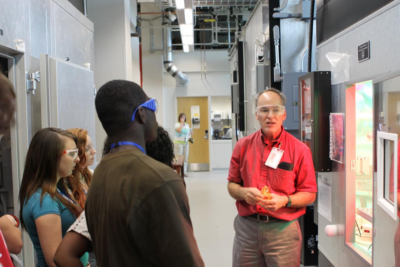 CAPE CANAVERAL, Fla. – Dr. Ray Wheeler explains a plant growth chamber to students in the Life Support and Habitation Systems Lab at the Space Life Sciences Lab facility.             The 26 honor students in chemistry and biology and their teachers got a chance to visit a number of high-tech labs at Kennedy Space Center as part of an effort to encourage students in the areas of science, technology, engineering and math. The tenth and eleventh grade students from Terry Parker High School in Jacksonville, Fla., visited a number of vastly different labs during their one-day tour. The group's visit to Kennedy was hosted by the Education Office as part of a nationwide effort by the National Lab Network to help introduce the nation's students to science careers. Photo credit: NASA/Jim Grossmann