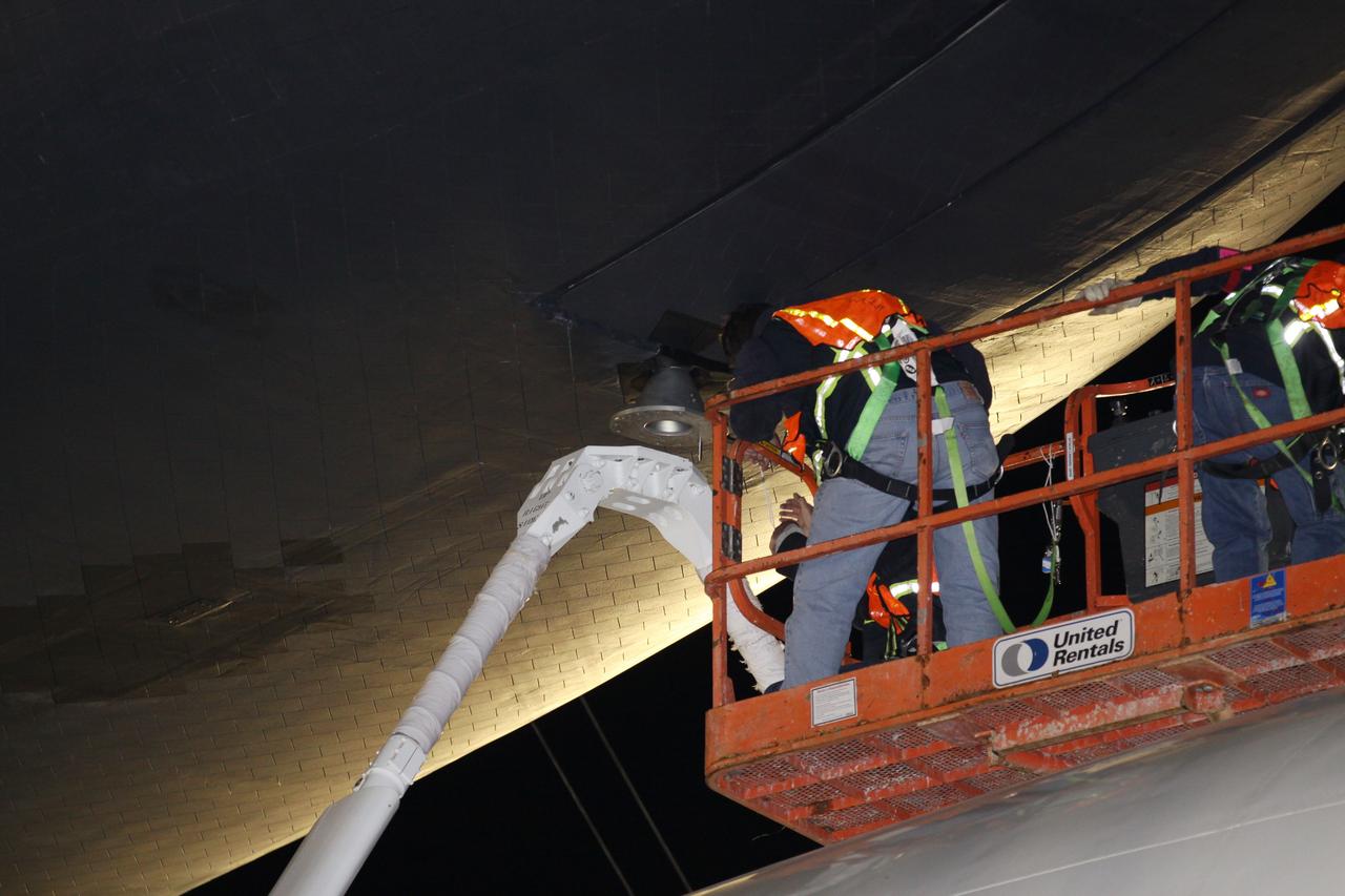 NEW YORK – Technicians detach space shuttle Enterprise from the top of NASA's shuttle carrier aircraft. The work took place at John F. Kennedy International Airport in New York City. Enterprise, a prototype built to test aspects of the space shuttle design, will be displayed at the Intrepid Sea, Air and Space Museum in New York. Photo credit: NASA/Kim Shiflett