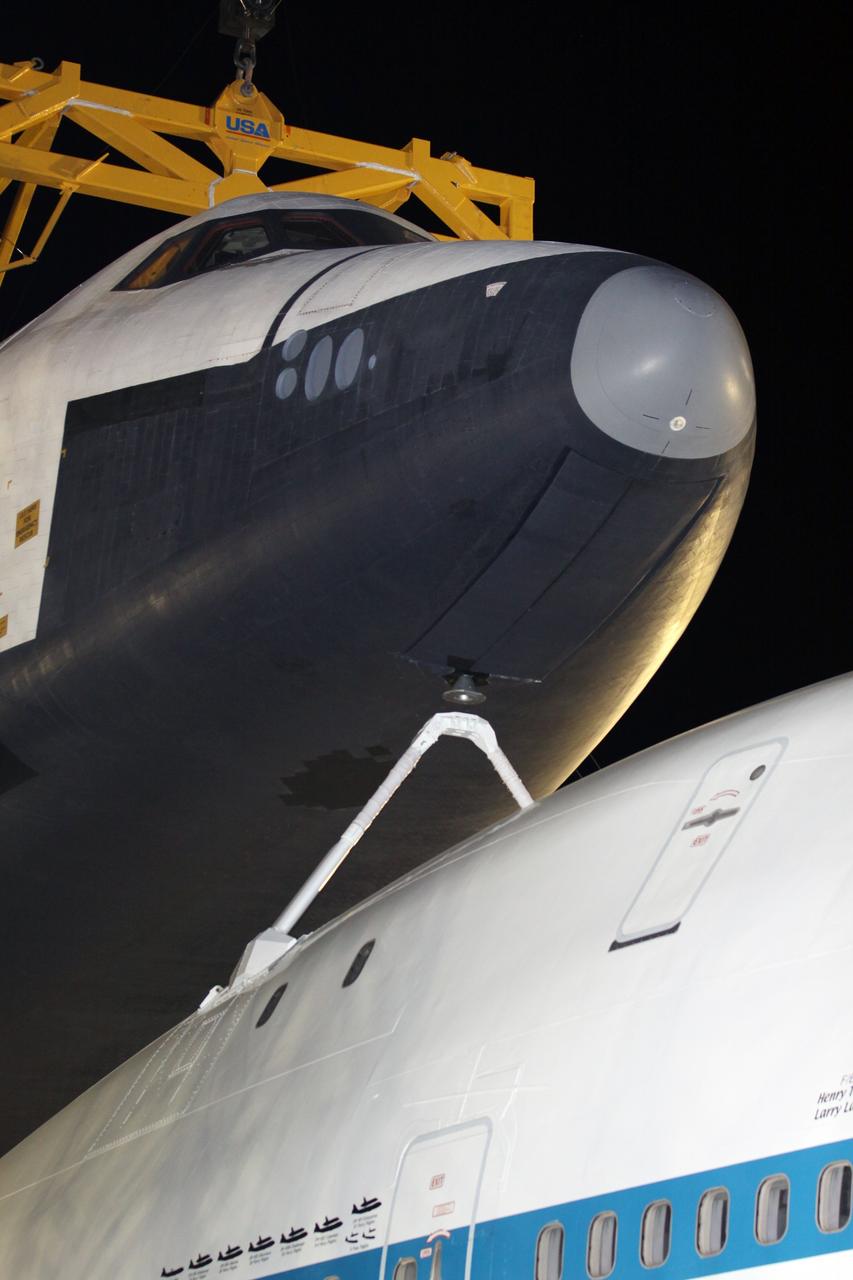 NEW YORK – Cranes lift space shuttle Enterprise from the top of NASA's shuttle carrier aircraft. The work took place at John F. Kennedy International Airport in New York City. Enterprise, a prototype built to test aspects of the space shuttle design, will be displayed at the Intrepid Sea, Air and Space Museum in New York. Photo credit: NASA/Kim Shiflett