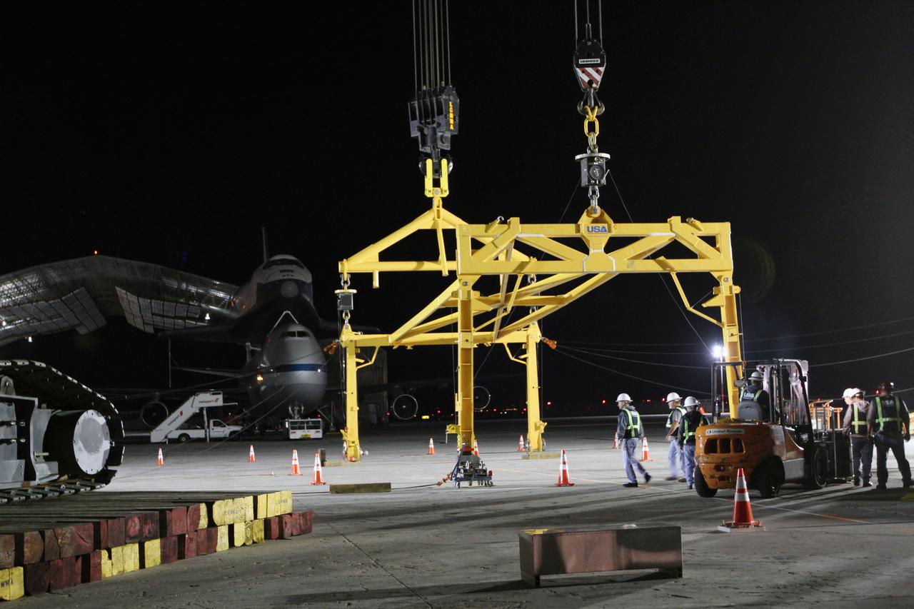 NEW YORK – Technicians ready the metal sling that will be used to lift space shuttle Enterprise from the top of NASA's shuttle carrier aircraft. The work took place at John F. Kennedy International Airport in New York City. Enterprise, a prototype built to test aspects of the space shuttle design, will be displayed at the Intrepid Sea, Air and Space Museum in New York. Photo credit: NASA/Kim Shiflett