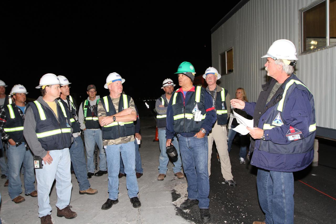 NEW YORK – Technicians review plans for lifting the space shuttle Enterprise from the top of NASA's shuttle carrier aircraft. The work took place at John F. Kennedy International Airport in New York City. Enterprise, a prototype built to test aspects of the space shuttle design, will be displayed at the Intrepid Sea, Air and Space Museum in New York. Photo credit: NASA/Kim Shiflett
