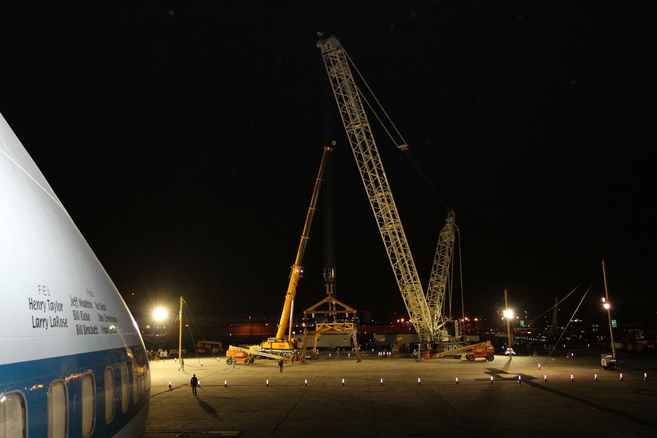 NEW YORK – Cranes and other equipment wait as NASA's shuttle carrier aircraft and space shuttle Enterprise are moved into place so the shuttle can be taken off the top of the aircraft. The work took place at John F. Kennedy International Airport in New York City. Enterprise, a prototype built to test aspects of the space shuttle design, will be displayed at the Intrepid Sea, Air and Space Museum in New York. Photo credit: NASA/Kim Shiflett