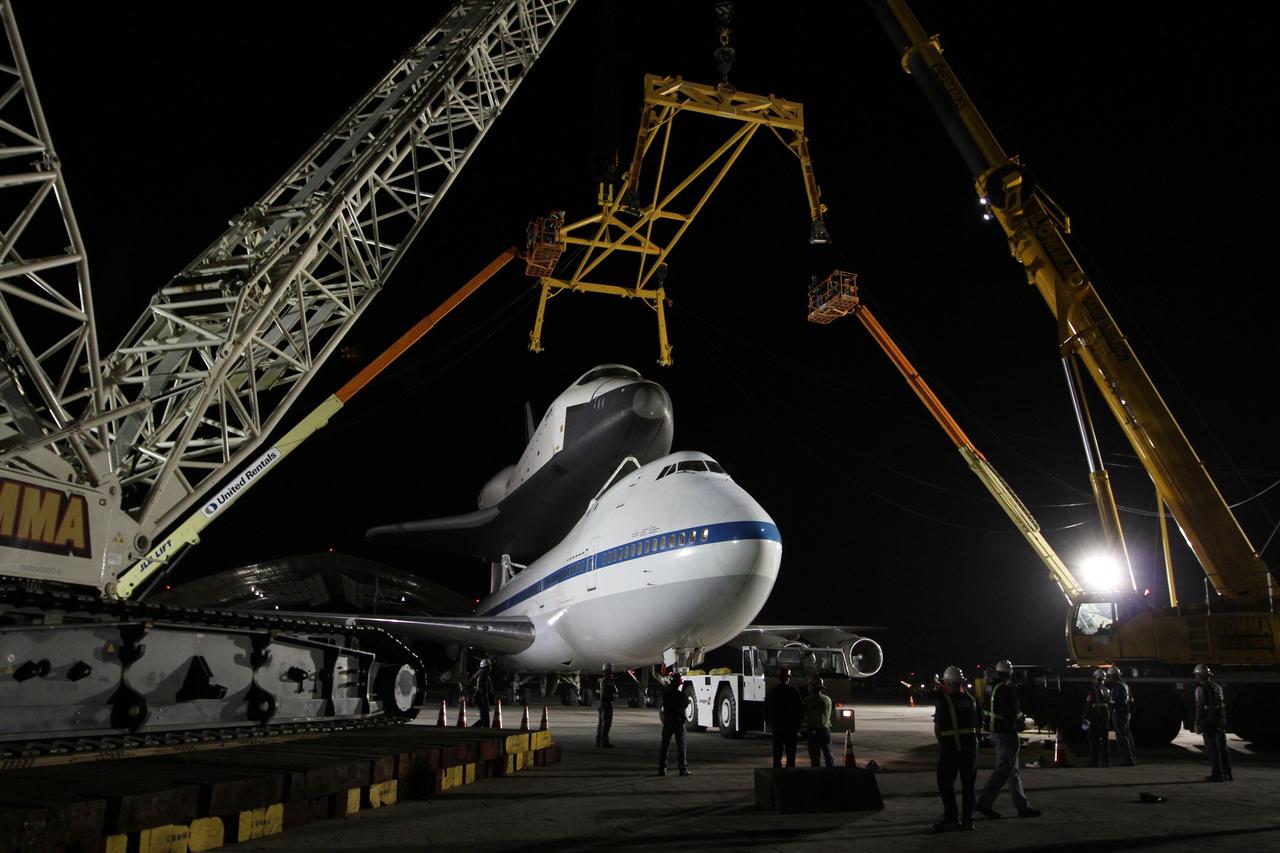 NEW YORK – Cranes and other equipment wait as NASA's shuttle carrier aircraft and space shuttle Enterprise are moved into place so the shuttle can be taken off the top of the aircraft. The work took place at John F. Kennedy International Airport in New York City. Enterprise, a prototype built to test aspects of the space shuttle design, will be displayed at the Intrepid Sea, Air and Space Museum in New York. Photo credit: NASA/Kim Shiflett