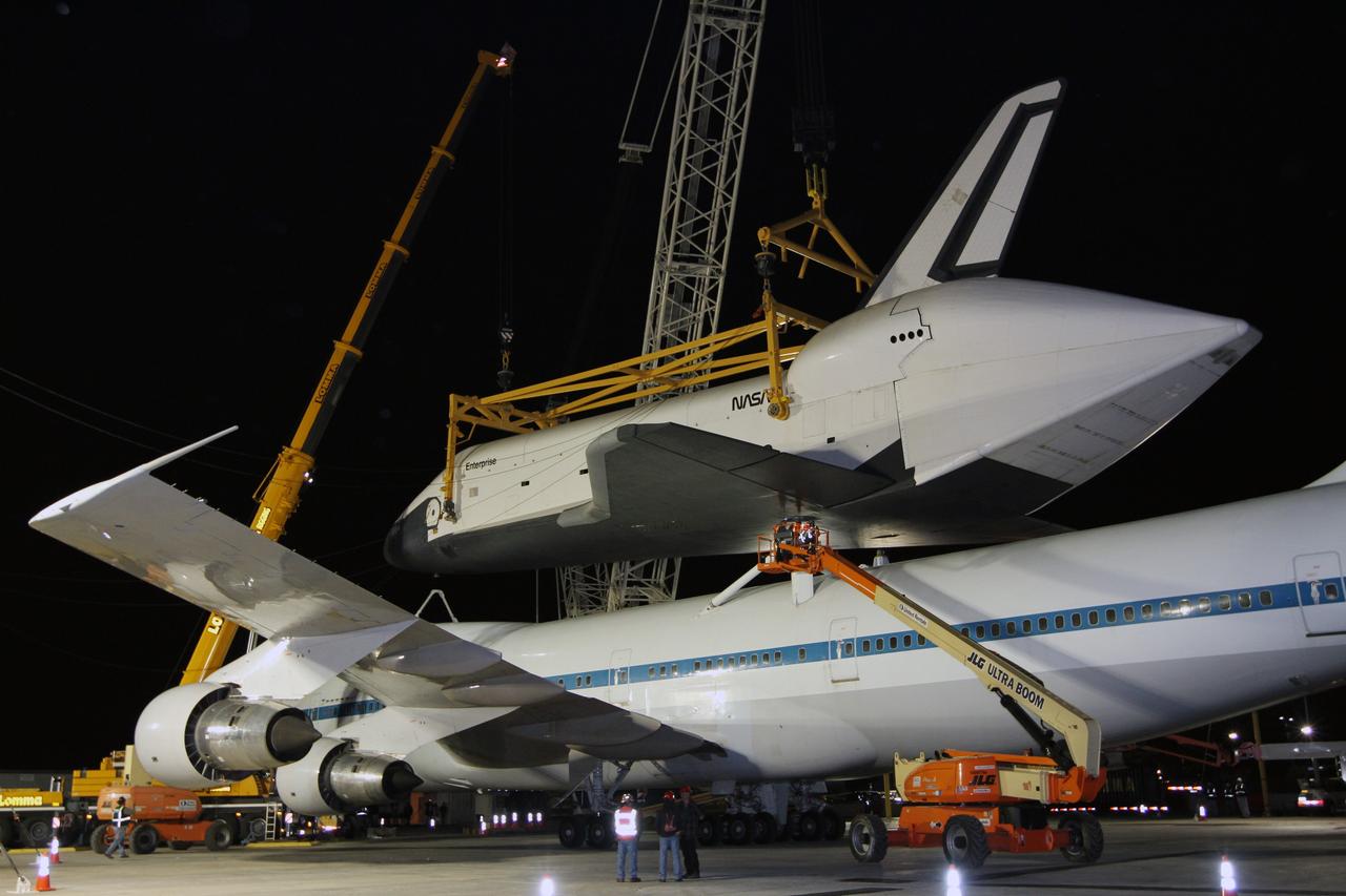 NEW YORK – Technicians detach space shuttle Enterprise from the top of NASA's shuttle carrier aircraft. The work took place at John F. Kennedy International Airport in New York City. Enterprise, a prototype built to test aspects of the space shuttle design, will be displayed at the Intrepid Sea, Air and Space Museum in New York. Photo credit: NASA/Kim Shiflett