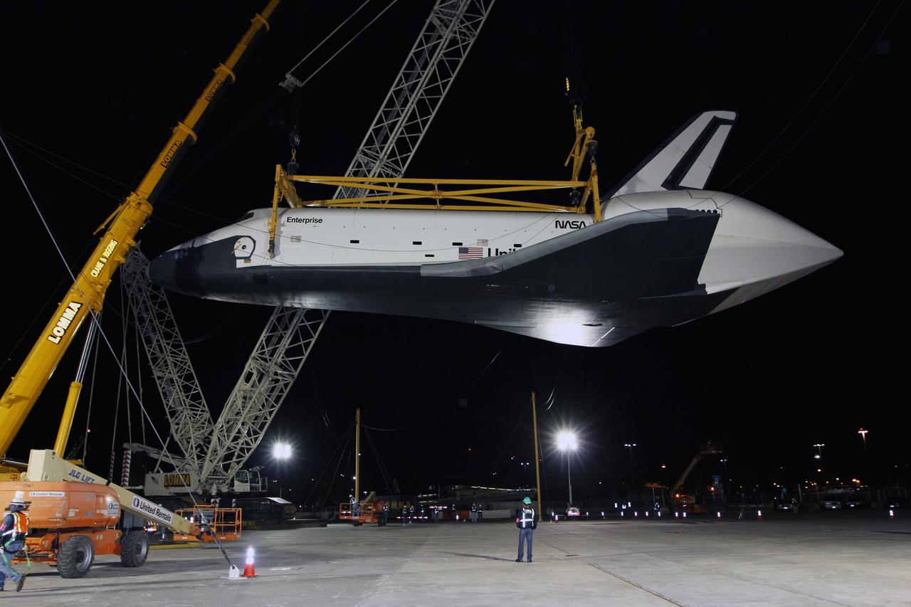 NEW YORK – Space shuttle Enterprise hangs in a specialized sling as a crew continues demate operations for the prototype spacecraft. The work took place at John F. Kennedy International Airport in New York City. Enterprise, a prototype built to test aspects of the space shuttle design, will be displayed at the Intrepid Sea, Air and Space Museum in New York. Photo credit: NASA/Kim Shiflett