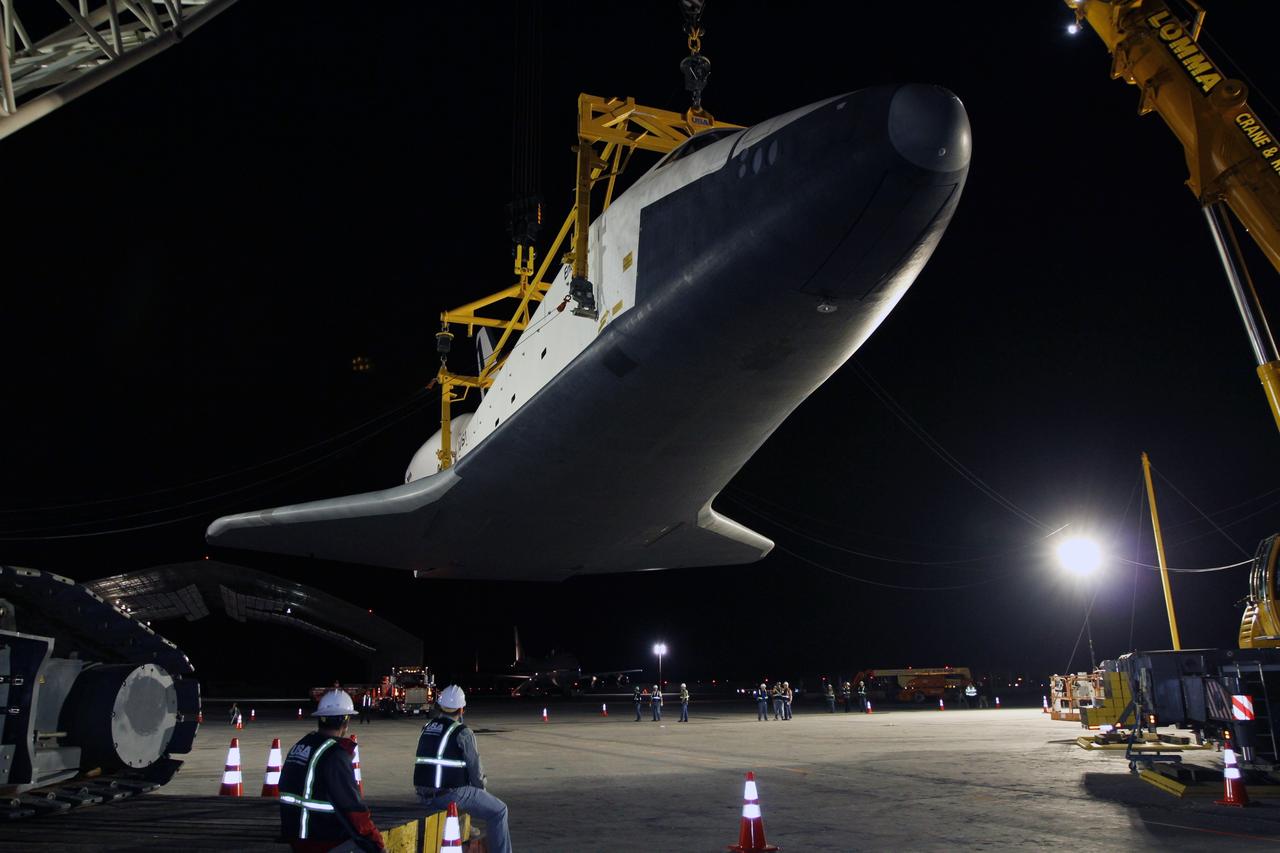 NEW YORK – Space shuttle Enterprise hangs in a specialized sling as a crew continues demate operations for the prototype spacecraft. The work took place at John F. Kennedy International Airport in New York City. Enterprise, a prototype built to test aspects of the space shuttle design, will be displayed at the Intrepid Sea, Air and Space Museum in New York. Photo credit: NASA/Kim Shiflett
