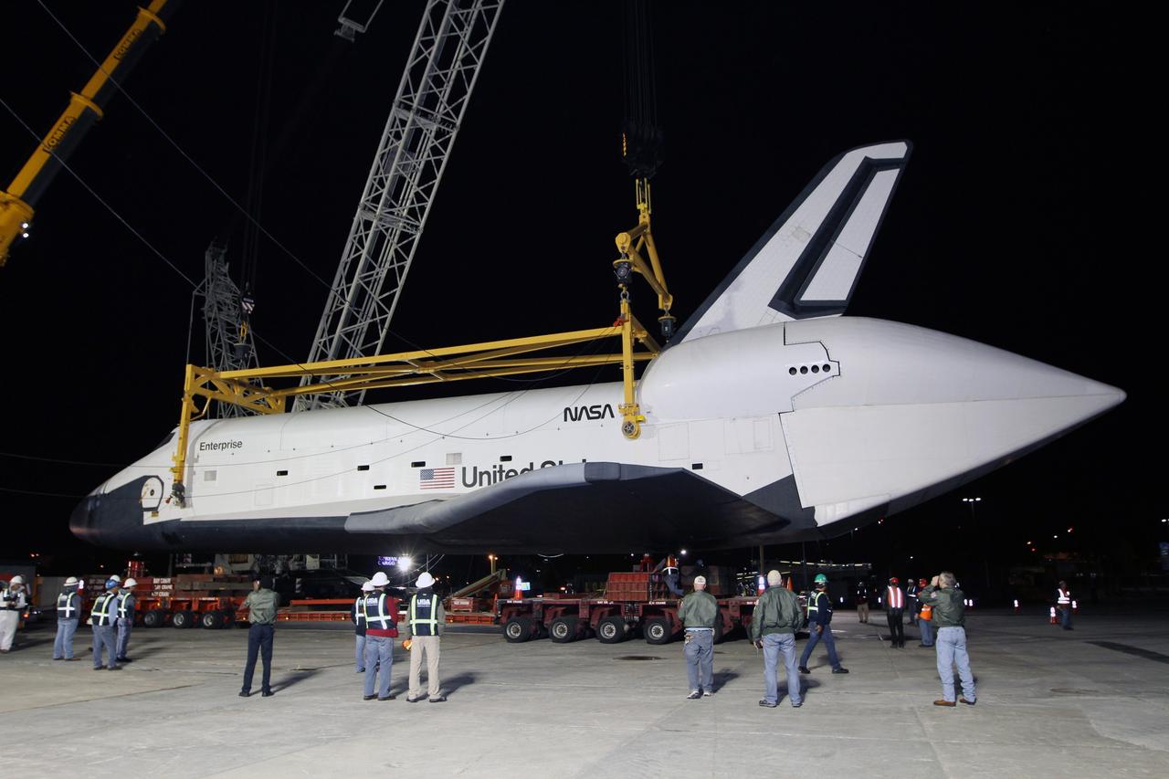 NEW YORK – Space shuttle Enterprise is lowered onto a  specialized truck bed so the prototype spacecraft can be moved into a hangar. The work took place at John F. Kennedy International Airport in New York City. Enterprise, a prototype built to test aspects of the space shuttle design, will be displayed at the Intrepid Sea, Air and Space Museum in New York. Photo credit: NASA/Kim Shiflett