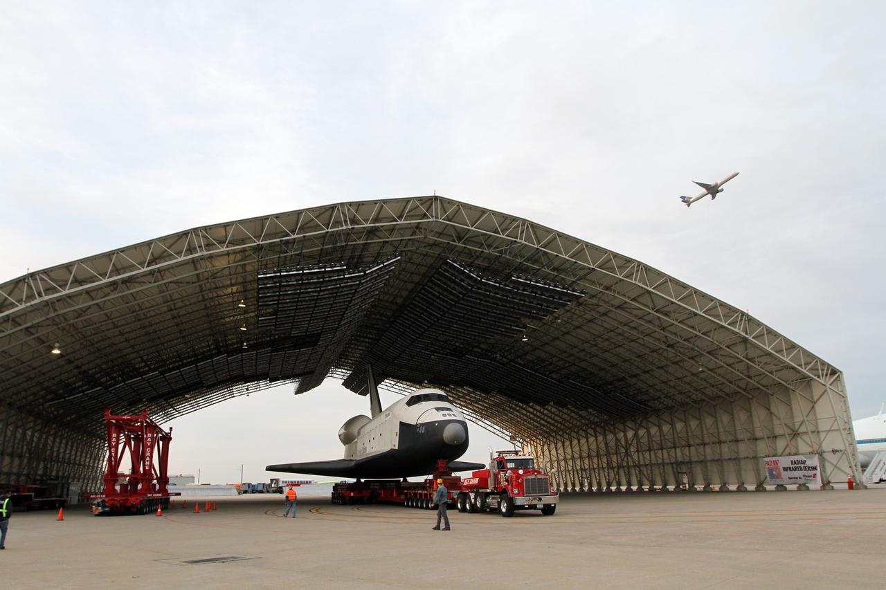 NEW YORK – Space shuttle Enterprise is rolled into a protective hangar at John F. Kennedy International Airport in New York City. Enterprise, a prototype built to test aspects of the space shuttle design, will be displayed at the Intrepid Sea, Air and Space Museum in New York. Photo credit: NASA/Kim Shiflett