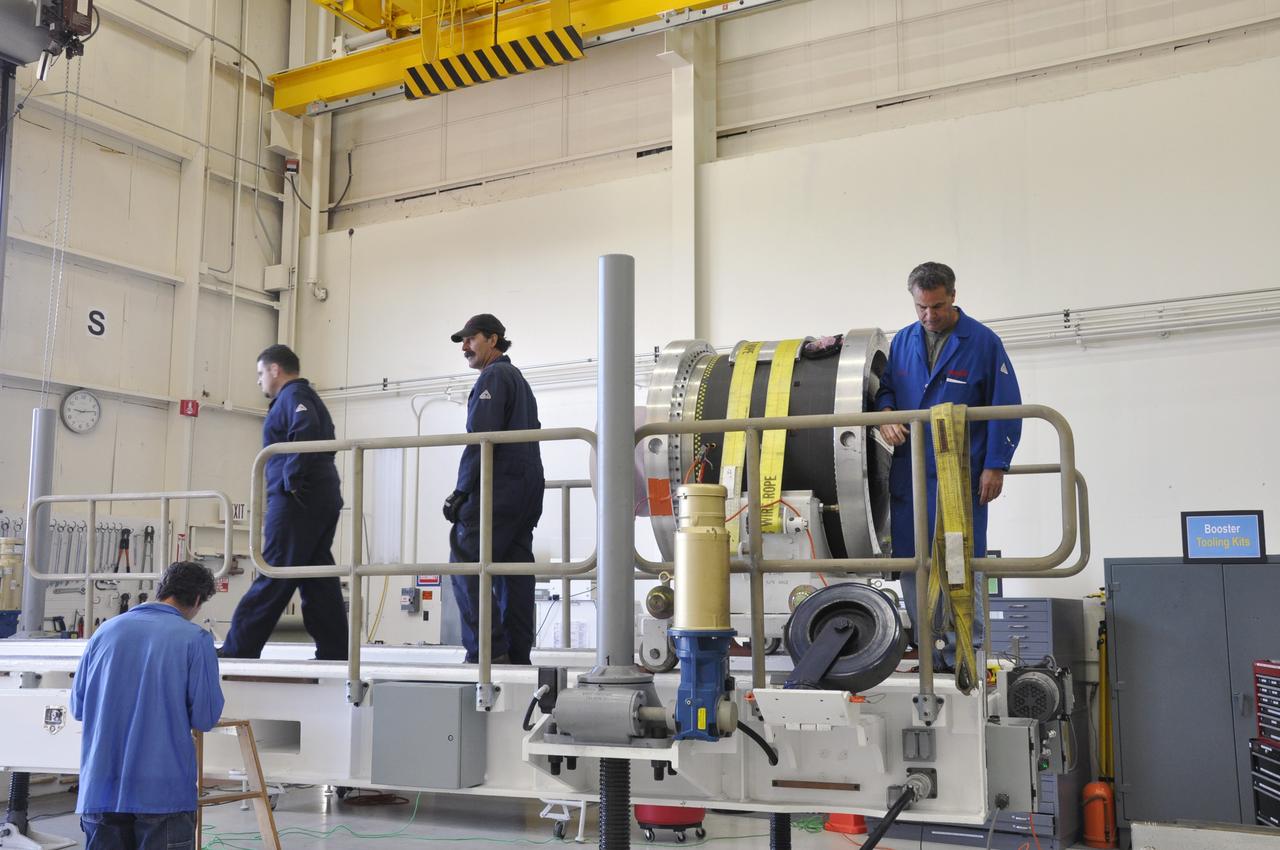 Vandenberg Air Force Base, Calif. – Inside a hangar at Vandenberg Air Force Base in California, technicians prepare to offload the third stage of the Orbital Sciences Pegasus XL rocket from the truck in which it was transported.      NASA’s Interface Region Imaging Spectrograph, or IRIS, spacecraft will launch aboard the Pegasus XL in late 2012. IRIS will open a new window of discovery by tracing the flow of energy and plasma through the chromospheres and transition region into the sun’s corona using spectrometry and imaging.  IRIS fills a crucial gap in our ability to advance studies of the sun-to-Earth connection by tracing the flow of energy and plasma through the foundation of the corona and heliosphere, or region around the sun. Photo credit: NASA/Randy Beaudoin