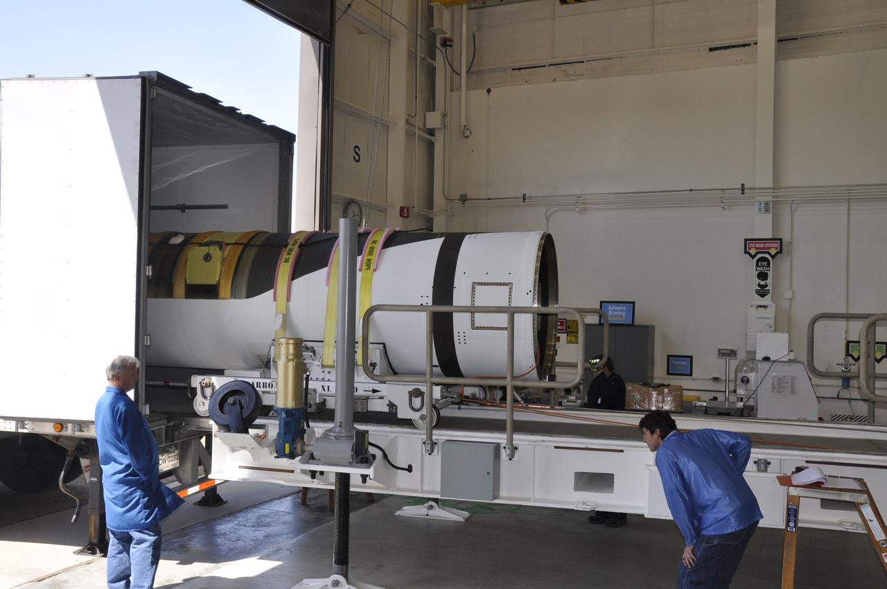Vandenberg Air Force Base, Calif. – At Vandenberg Air Force Base in California, technicians offload the first stage of the Orbital Sciences Pegasus XL rocket from the truck in which it was transported.      NASA’s Interface Region Imaging Spectrograph, or IRIS, spacecraft will launch aboard the Pegasus XL in late 2012. IRIS will open a new window of discovery by tracing the flow of energy and plasma through the chromospheres and transition region into the sun’s corona using spectrometry and imaging.  IRIS fills a crucial gap in our ability to advance studies of the sun-to-Earth connection by tracing the flow of energy and plasma through the foundation of the corona and heliosphere, or region around the sun. Photo credit: NASA/Randy Beaudoin