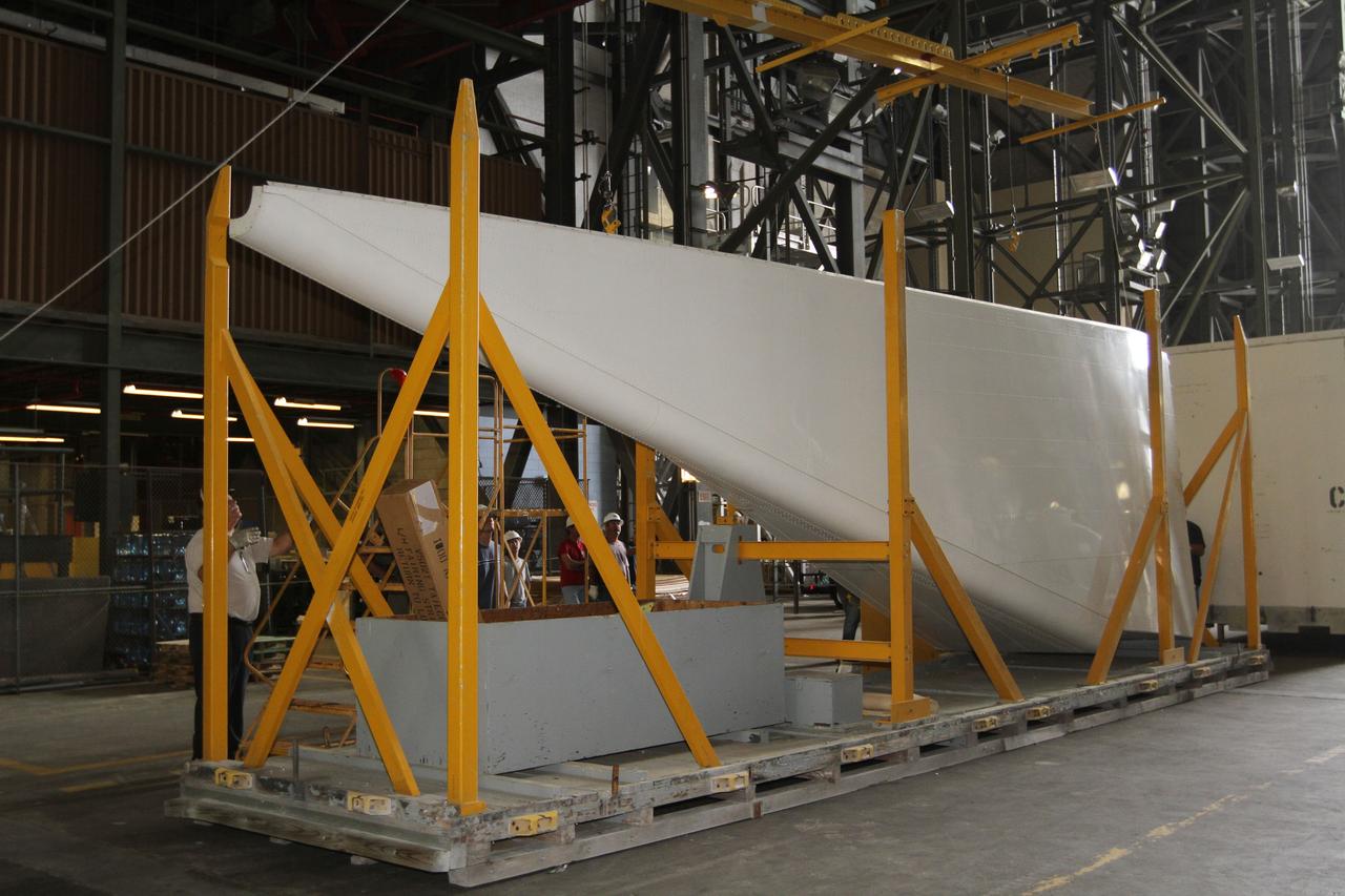 CAPE CANAVERAL, Fla. – Inside the Vehicle Assembly Building at NASA’s Kennedy Space Center in Florida, United Space Alliance technicians prepare the right side tail cone for buildup on space shuttle Endeavour. The tail cone protects space shuttle main engines during ferry flights on top of the Shuttle Carrier Aircraft, or SCA. The work is part of Transition and Retirement of the remaining space shuttles, Endeavour and Atlantis. Endeavour is being prepared for public display at the California Science Center in Los Angeles. Its ferry flight to California is targeted for mid-September. Endeavour was the last space shuttle added to NASA’s orbiter fleet. Over the course of its 19-year career, Endeavour spent 299 days in space during 25 missions. For more information, visit http://www.nasa.gov/shuttle. Photo credit: NASA/Kim Shiflett