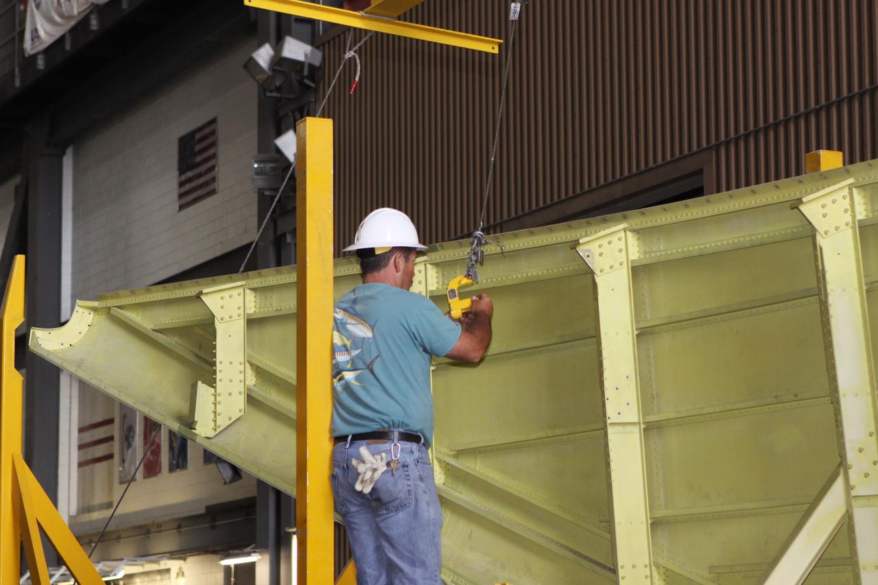 CAPE CANAVERAL, Fla. – Inside the Vehicle Assembly Building at NASA’s Kennedy Space Center in Florida, a United Space Alliance technician helps prepare the right side tail cone for buildup on space shuttle Endeavour. The tail cone protects space shuttle main engines during ferry flights on top of the Shuttle Carrier Aircraft, or SCA. The work is part of Transition and Retirement of the remaining space shuttles, Endeavour and Atlantis. Endeavour is being prepared for public display at the California Science Center in Los Angeles. Its ferry flight to California is targeted for mid-September. Endeavour was the last space shuttle added to NASA’s orbiter fleet. Over the course of its 19-year career, Endeavour spent 299 days in space during 25 missions. For more information, visit http://www.nasa.gov/shuttle. Photo credit: NASA/Jim Grossmann