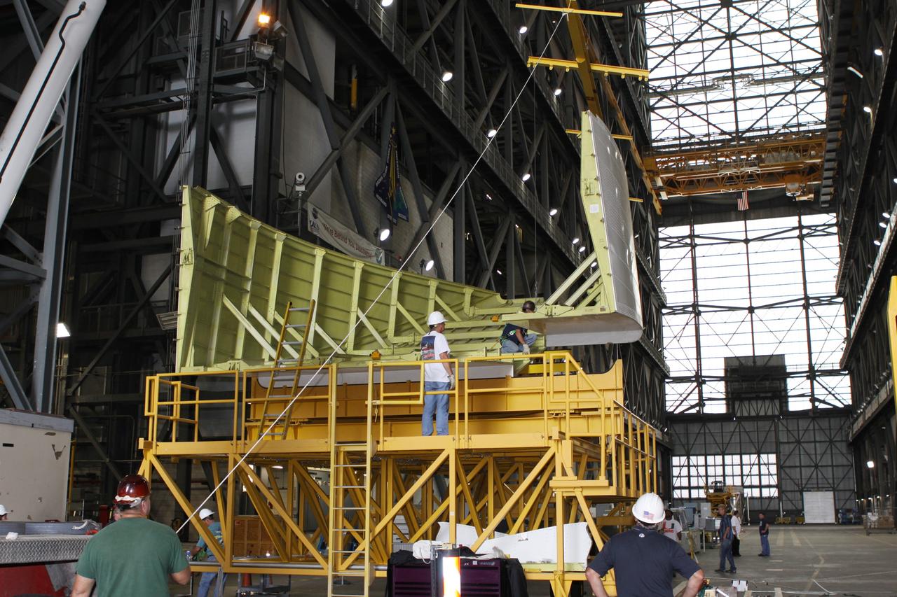 CAPE CANAVERAL, Fla. – Inside the Vehicle Assembly Building at NASA’s Kennedy Space Center in Florida, United Space Alliance technicians prepare the right side tail cone for buildup on space shuttle Endeavour. The tail cone protects space shuttle main engines during ferry flights on top of the Shuttle Carrier Aircraft, or SCA. The work is part of Transition and Retirement of the remaining space shuttles, Endeavour and Atlantis. Endeavour is being prepared for public display at the California Science Center in Los Angeles. Its ferry flight to California is targeted for mid-September. Endeavour was the last space shuttle added to NASA’s orbiter fleet. Over the course of its 19-year career, Endeavour spent 299 days in space during 25 missions. For more information, visit http://www.nasa.gov/shuttle. Photo credit: NASA/Jim Grossmann