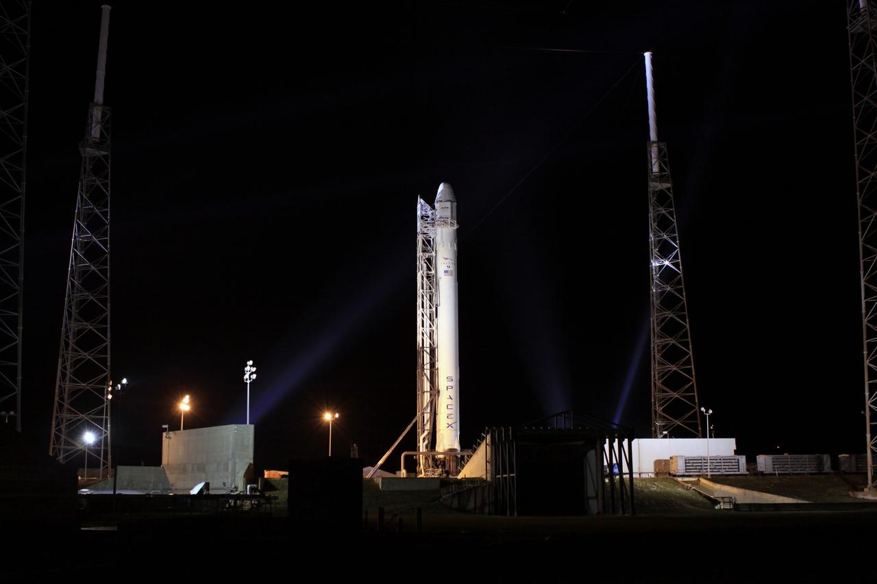CAPE CANAVERAL, Fla. – The SpaceX Falcon 9 rocket is nestled between the lightning protection system towers surrounding the pad at Space Launch Complex-40 on Cape Canaveral Air Force Station in Florida.      Liftoff with the SpaceX Dragon capsule aboard is set for 4:55 a.m. EDT on May 19. The launch will be the company's second demonstration test flight for NASA's Commercial Orbital Transportation Services Program, or COTS. During the flight, the capsule will conduct a series of check-out procedures to test and prove its systems, including rendezvous and berthing with the International Space Station. If the capsule performs as planned, the cargo and experiments it is carrying will be transferred to the station. The cargo includes food, water and provisions for the station’s Expedition crews, such as clothing, batteries and computer equipment. Under COTS, NASA has partnered with two aerospace companies to deliver cargo to the station. For more information, visit http://www.nasa.gov/spacex.  Photo credit: NASA/Jim Grossmann