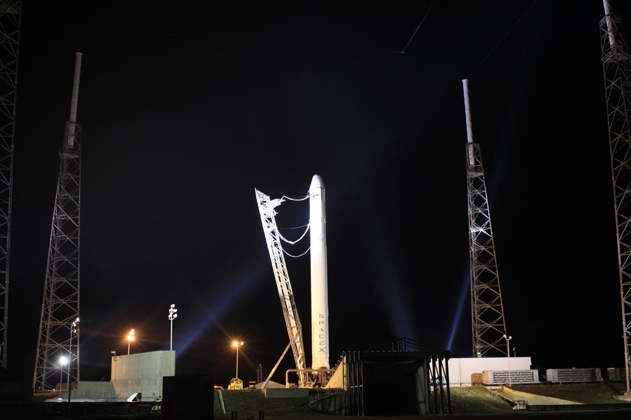 CAPE CANAVERAL, Fla. – Umbilical lines connect the strongback to the SpaceX Falcon 9 rocket which has just arrived on the pad at Space Launch Complex-40 on Cape Canaveral Air Force Station in Florida.      Liftoff with the SpaceX Dragon capsule aboard is set for 4:55 a.m. EDT on May 19. The launch will be the company's second demonstration test flight for NASA's Commercial Orbital Transportation Services Program, or COTS. During the flight, the capsule will conduct a series of check-out procedures to test and prove its systems, including rendezvous and berthing with the International Space Station. If the capsule performs as planned, the cargo and experiments it is carrying will be transferred to the station. The cargo includes food, water and provisions for the station’s Expedition crews, such as clothing, batteries and computer equipment. Under COTS, NASA has partnered with two aerospace companies to deliver cargo to the station. For more information, visit http://www.nasa.gov/spacex.  Photo credit: NASA/Jim Grossmann