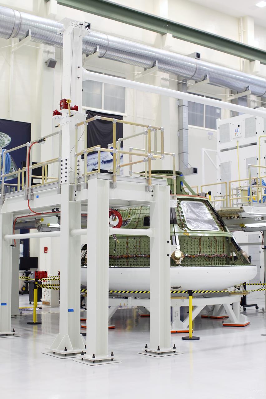 CAPE CANAVERAL, Fla. – Inside the Operations and Checkout Building high bay at NASA’s Kennedy Space Center in Florida, the Orion ground test vehicle sits in a work stand. The heat panels have been removed. During a tour of the facility, media representatives viewed Orion, several processing stations, and the Orion Test and Launch Control Center. The ground test vehicle will remain at Kennedy for acoustic and modal testing. The heat shield on the bottom of the module will be removed and replaced with a more flight-like heat shield that was built by Lockheed Martin in Denver and will be shipped to Kennedy for installation. The test vehicle will then be in its vehicle configuration for the splashdown test at Langley as NASA prepares for Exploration Flight Test-1. Photo credit: NASA/Frankie Martin