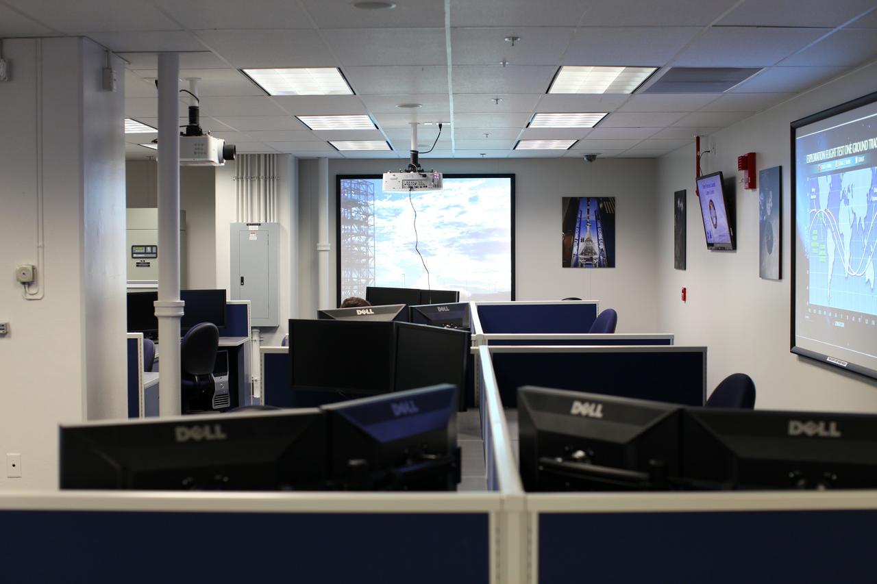 CAPE CANAVERAL, Fla. – Inside the Operations and Checkout Building at NASA’s Kennedy Space Center in Florida, media tour the new Orion Test and Launch Control Center. During a tour of the facility, media representatives viewed Orion, several processing stations, and the Orion Test and Launch Control Center. The ground test vehicle will remain at Kennedy for acoustic and modal testing. The heat shield on the bottom of the module will be removed and replaced with a more flight-like heat shield that was built by Lockheed Martin in Denver and will be shipped to Kennedy for installation. The test vehicle will then be in its vehicle configuration for the splashdown test at Langley as NASA prepares for Exploration Flight Test-1. Photo credit: NASA/Frankie Martin