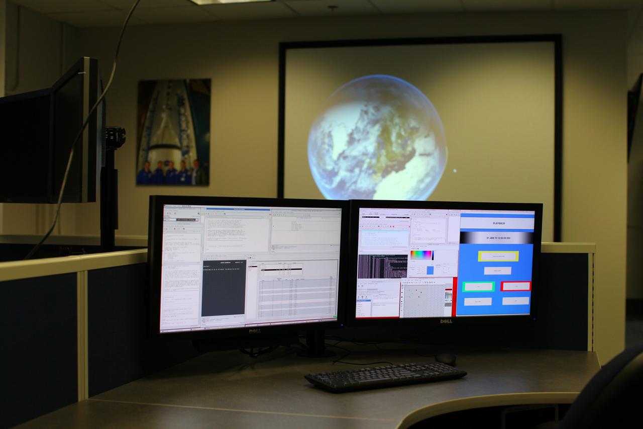 CAPE CANAVERAL, Fla. – Inside the Operations and Checkout Building at NASA’s Kennedy Space Center in Florida, media tour the new Orion Test and Launch Control Center. During a tour of the facility, media representatives viewed Orion, several processing stations, and the Orion Test and Launch Control Center. The ground test vehicle will remain at Kennedy for acoustic and modal testing. The heat shield on the bottom of the module will be removed and replaced with a more flight-like heat shield that was built by Lockheed Martin in Denver and will be shipped to Kennedy for installation. The test vehicle will then be in its vehicle configuration for the splashdown test at Langley as NASA prepares for Exploration Flight Test-1. Photo credit: NASA/Frankie Martin
