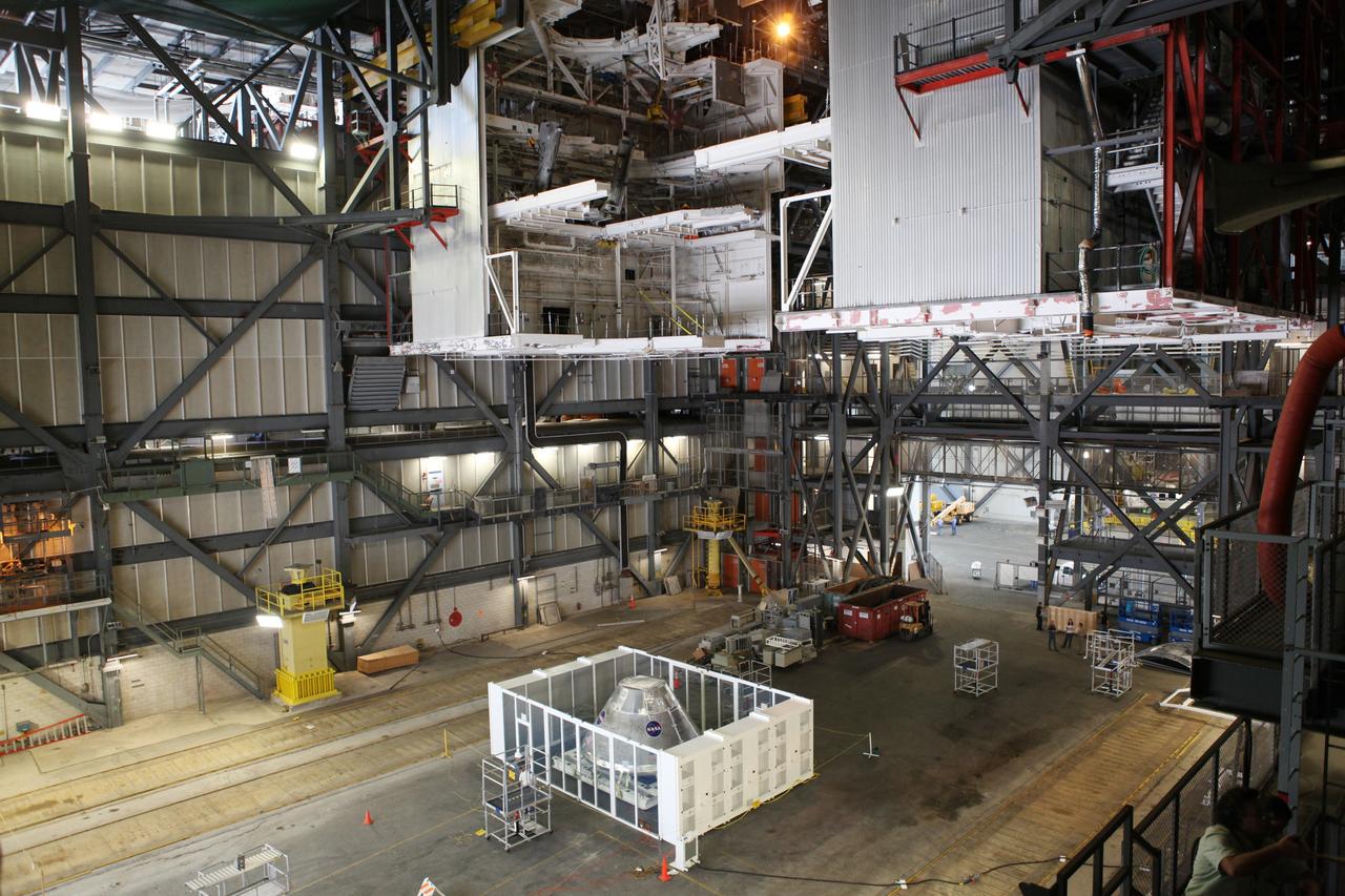 CAPE CANAVERAL, Fla. - An Orion test capsule sits inside a temporary clean room in High Bay 3 of the Vehicle Assembly Building at NASA's Kennedy Space Center in Florida during testing. The clean room, built by Astrotech, uses air flow produced by two banks of fans to keep particles from settling on the surface of a spacecraft during processing. Engineers are considering using the design in the future to protect the spacecraft after it is secured to the top of the Space Launch System rocket. Photo credit: NASA/Dmitri Gerondidakis