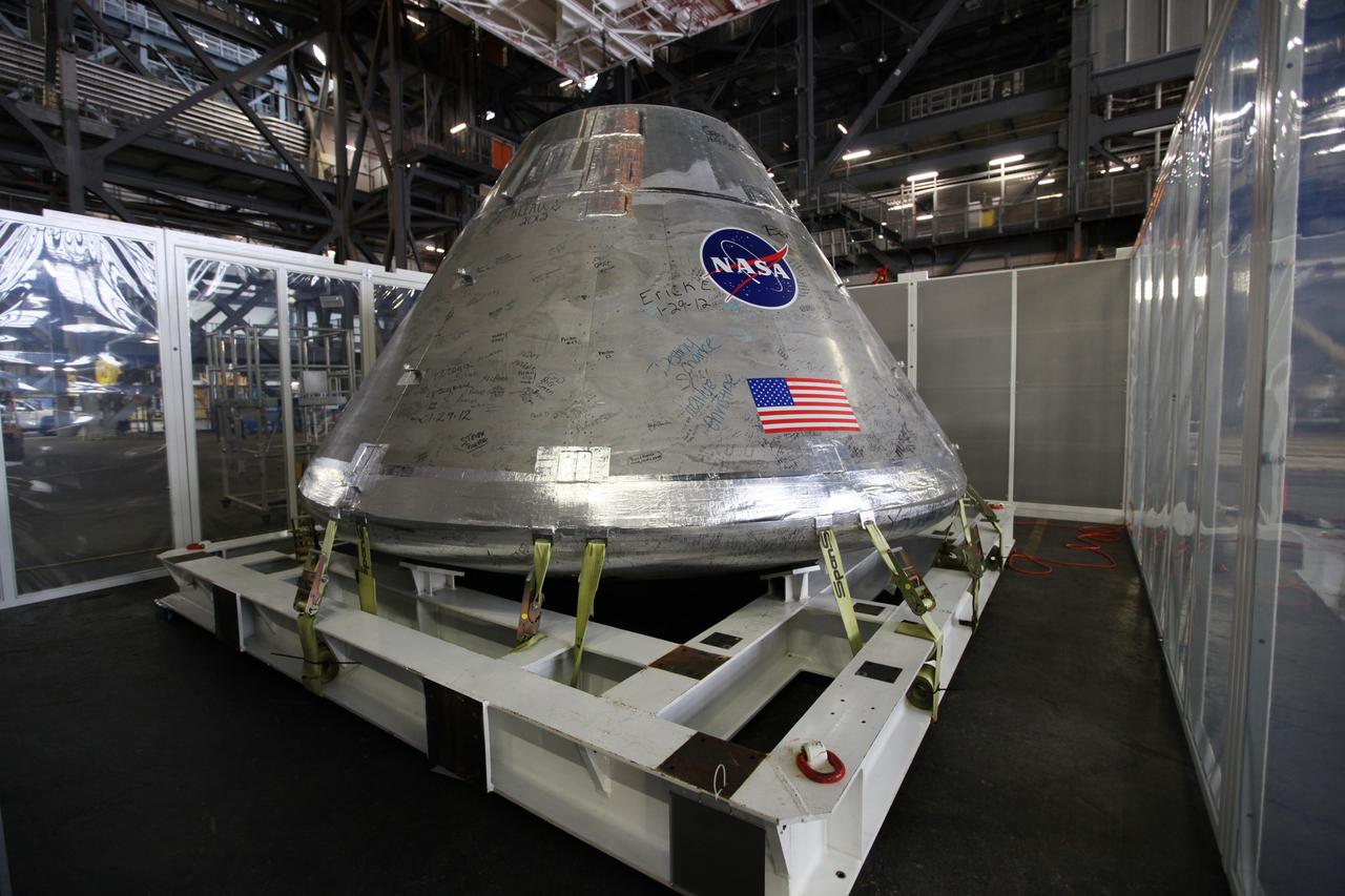 CAPE CANAVERAL, Fla. - An Orion test capsule sits inside a temporary clean room in High Bay 3 of the Vehicle Assembly Building at NASA's Kennedy Space Center in Florida during testing. The clean room, built by Astrotech, uses air flow produced by two banks of fans to keep particles from settling on the surface of a spacecraft during processing. Engineers are considering using the design in the future to protect the spacecraft after it is secured to the top of the Space Launch System rocket. Photo credit: NASA/Dmitri Gerondidakis