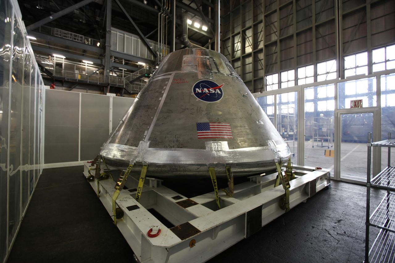 CAPE CANAVERAL, Fla. - An Orion test capsule sits inside a temporary clean room in High Bay 3 of the Vehicle Assembly Building at NASA's Kennedy Space Center in Florida during testing. The clean room, built by Astrotech, uses air flow produced by two banks of fans to keep particles from settling on the surface of a spacecraft during processing. Engineers are considering using the design in the future to protect the spacecraft after it is secured to the top of the Space Launch System rocket. Photo credit: NASA/Dmitri Gerondidakis