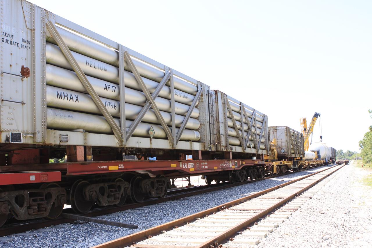 CAPE CANAVERAL, Fla. – At the NASA Railroad yard at Kennedy Space Center in Florida, helium tank cars have been removed from their trucks and loaded onto flat cars in preparation for a journey to the Florida East Coast Railway interchange in Titusville, Fla., where the train’s tank cars will be transferred for delivery to the SpaceX engine test complex outside McGregor, Texas.    The railroad cars were needed in support of the Space Shuttle Program but currently are not in use by NASA following the completion of the program in 2011. Originally, the tankers belonged to the U.S. Bureau of Mines.  At the peak of the shuttle program, there were approximately 30 cars in the fleet.  About half the cars were returned to the bureau as launch activity diminished. Five tank cars are being loaned to SpaceX and repurposed to support their engine tests in Texas. Eight cars previously were shipped to California on loan to support the SpaceX Falcon 9 rocket launches from Space Launch Complex-4 on Vandenberg Air Force Base.  SpaceX already has three helium tank cars previously used for the shuttle program at Space Launch Complex-40 on Cape Canaveral Air Force Station in Florida. For more information, visit http://www.nasa.gov/spacex.  Photo credit: NASA/Jim Grossmann