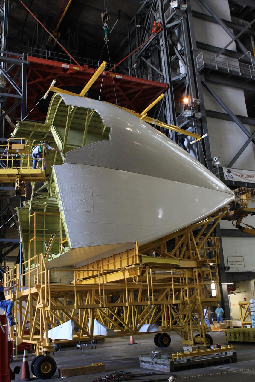 CAPE CANAVERAL, Fla. – In the transfer isle of the Vehicle Assembly Building at NASA’s Kennedy Space Center in Florida, technicians finish building the tail cone that will be installed around space shuttle Endeavour’s three replica shuttle main engines for protection. The tail cone protects the main engines during ferry flights on top of the Shuttle Carrier Aircraft, or SCA. The work is part of the Space Shuttle Program’s transition and retirement processing of shuttle Endeavour.           Endeavour is being prepared for public display at the California Science Center in Los Angeles. Its ferry flight to California is targeted for mid-September. Endeavour was the last space shuttle added to NASA’s orbiter fleet. Over the course of its 19-year career, Endeavour spent 299 days in space during 25 missions. For more information, visit http://www.nasa.gov/shuttle. Photo credit: NASA/Jim Grossmann