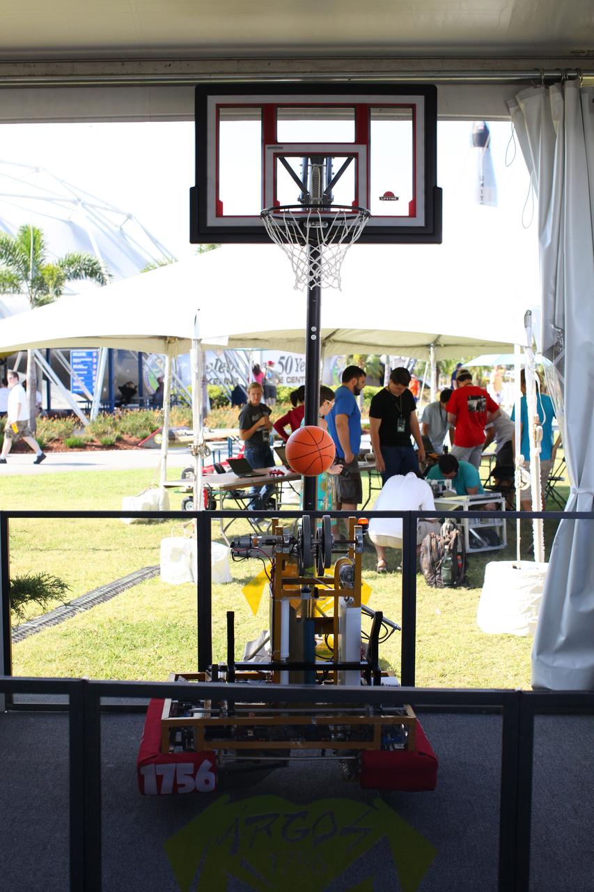 CAPE CANAVERAL, Fla. – At NASA’s Kennedy Space Center Visitor Complex in Florida, the For Inspiration and Recognition of Science and Technology FIRST Argos Team 1756 robot from Limestone Community, Brimfield and Richwoods High Schools in Peoria, Ill., is on display in Caterpillar’s sponsor booth at NASA’s Lunabotics Mining Competition.    The mining competition is sponsored by NASA Kennedy Space Center’s Education Office for the agency’s Exploration Systems Mission Directorate. Undergraduate and graduate students from more than 50 universities and colleges in the U.S. and other countries use their remote-controlled Lunabots to maneuver and dig in a supersized sandbox filled with a crushed material that has characteristics similar to lunar soil. For more information, visit www.nasa.gov/lunabotics. Photo credit: NASA/Frankie Martin