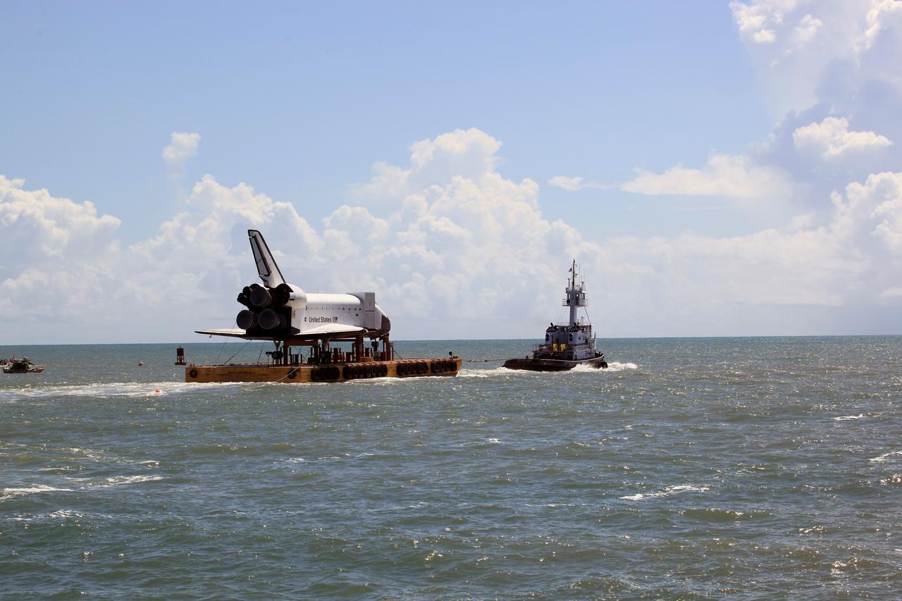 CAPE CANAVERAL, Fla. – The high-fidelity space shuttle model nears the mouth of Port Canaveral as it heads toward the Atlantic Ocean, in the distance. The model is en route by barge from NASA’s Kennedy Space Center in Florida to Space Center Houston, NASA Johnson Space Center’s official visitor center. Its journey to Texas will take it south along the Florida coastline, around Key West and into the Gulf of Mexico. The model was built in Apopka, Fla., by Guard-Lee and installed at the Kennedy Space Center Visitor Complex in 1993. The model is expected to arrive June 1 in Houston and to be transported June 3 to Space Center Houston, its final destination, where it will become part of a unique display telling the story of the space shuttle’s achievements and the nationwide team that made them possible. For more information about Space Center Houston, visit http://www.spacecenter.org. Photo credit: NASA/Dimitri Gerondidakis