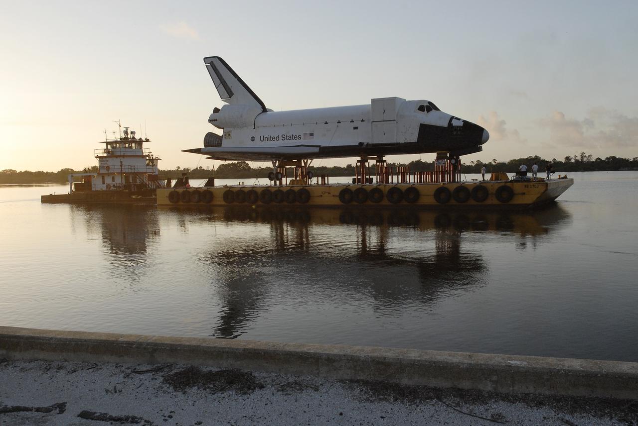 CAPE CANAVERAL, Fla. – As the sun rises over the turn basin at NASA’s Kennedy Space Center in Florida, the barge transporting the high-fidelity space shuttle model begins the journey from Kennedy to Johnson Space Center's visitor center in Houston. The model was built in Apopka, Fla., by Guard-Lee and installed at Kennedy Space Center Visitor Complex in 1993.The model has been parked at the turn basin the past five months to allow the Kennedy Space Center Visitor Complex to begin building a new facility to display space shuttle Atlantis in 2013. For more information about Johnson’s visitor center, called Space Center Houston, visit http://www.spacecenter.org. Photo credit: NASA/Charisse Nahser