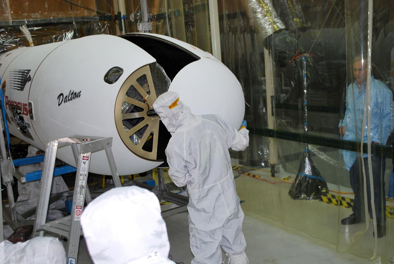 VANDENBERG AFB, Calif. – Technicians install the second half of the payload fairing over the NuSTAR spacecraft as they continue to process the spacecraft and its Pegasus rocket for launch. NuSTAR stands for Nuclear Spectroscopic Telescope Array. Photo credit: NASA/Randy Beaudoin