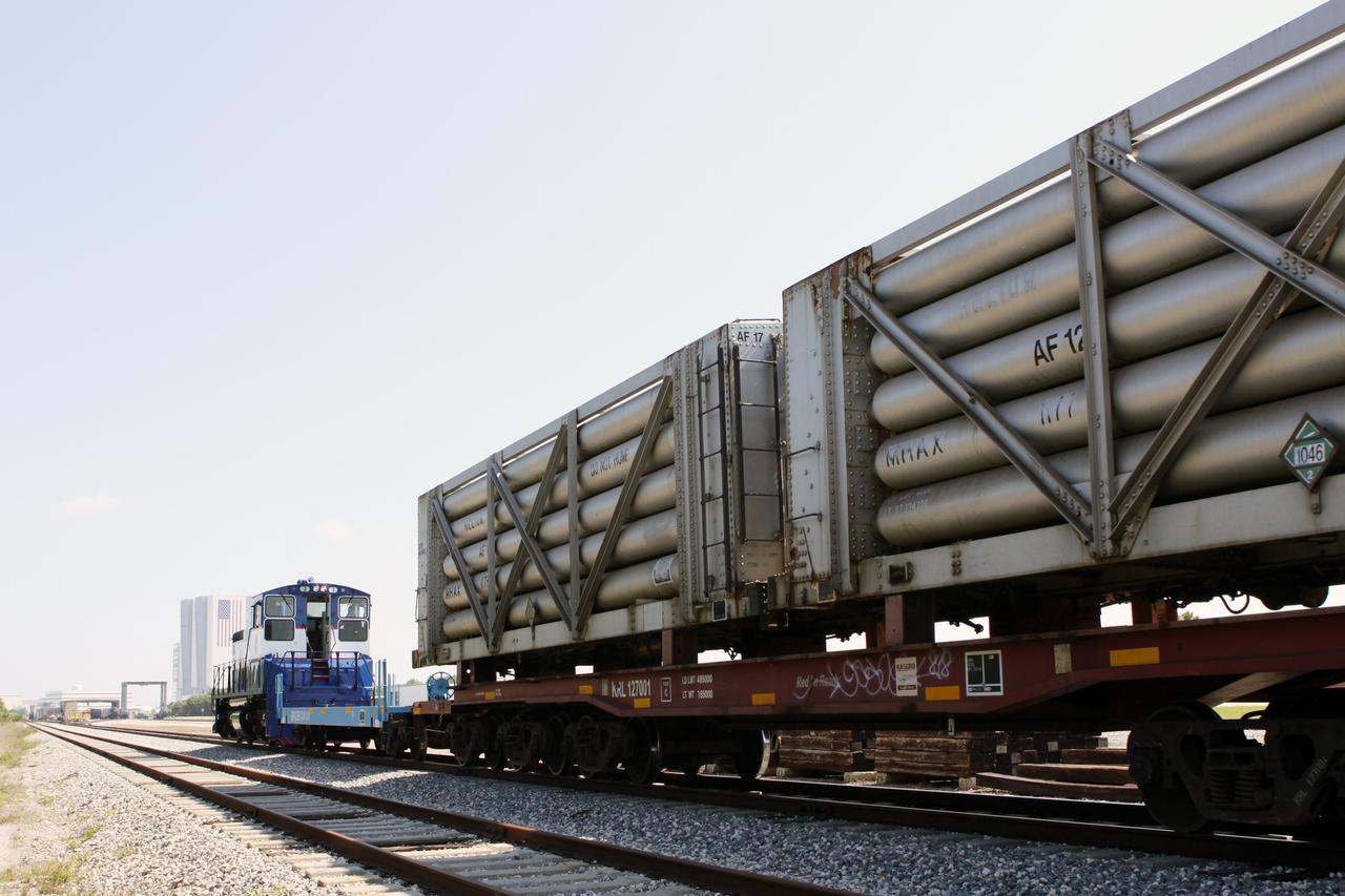 CAPE CANAVERAL, Fla. – At the NASA Railroad Yard at NASA’s Kennedy Space Center in Florida, preparations are under way for the departure of a train made up of tank cars.  The train will pass by Kennedy’s 525-foot-tall Vehicle Assembly Building in the background.  The train is headed for the Florida East Coast Railway interchange in Titusville, Fla., where the train’s helium tank cars, a liquid oxygen tank car, and a liquid hydrogen dewar or tank car will be transferred for delivery to the SpaceX engine test complex outside McGregor, Texas.        The railroad cars were needed in support of the Space Shuttle Program but currently are not in use by NASA following the completion of the program in 2011. Originally, the tankers belonged to the U.S. Bureau of Mines.  At the peak of the shuttle program, there were approximately 30 cars in the fleet.  About half the cars were returned to the bureau as launch activity diminished. Five tank cars are being loaned to SpaceX and repurposed to support their engine tests in Texas. Eight cars previously were shipped to California on loan to support the SpaceX Falcon 9 rocket launches from Space Launch Complex-4 on Vandenberg Air Force Base.  SpaceX already has three helium tank cars previously used for the shuttle program at Space Launch Complex-40 on Cape Canaveral Air Force Station in Florida. For more information, visit http://www.nasa.gov/spacex.  Photo credit: NASA/Jim Grossmann