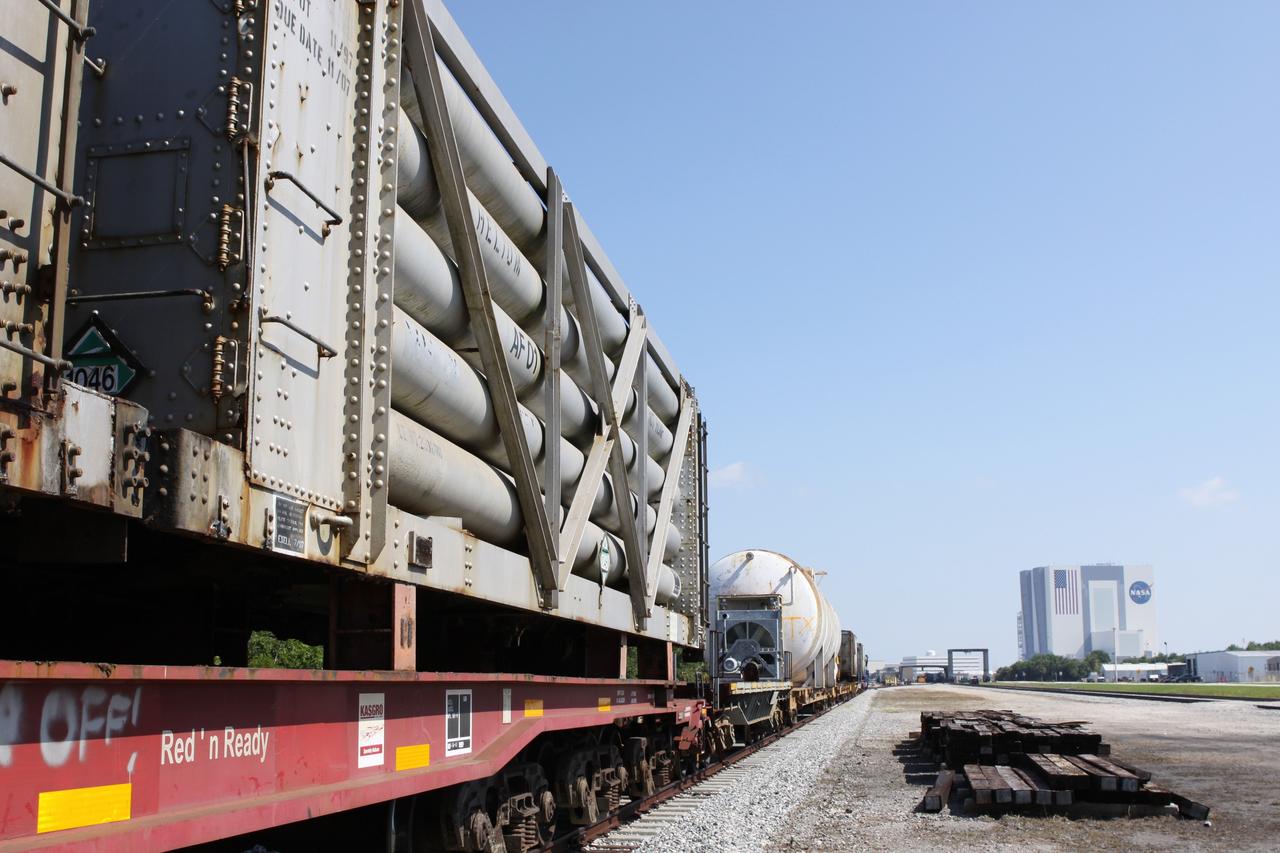 CAPE CANAVERAL, Fla. – At the NASA Railroad Yard at NASA’s Kennedy Space Center in Florida, preparations are under way for the departure of a train made up of tank cars.  The railroad’s track runs past Kennedy’s 525-foot-tall Vehicle Assembly Building in the background.  The train is headed for the Florida East Coast Railway interchange in Titusville, Fla., where the train’s helium tank cars, a liquid oxygen tank car, and a liquid hydrogen dewar or tank car will be transferred for delivery to the SpaceX engine test complex outside McGregor, Texas.      The railroad cars were needed in support of the Space Shuttle Program but currently are not in use by NASA following the completion of the program in 2011. Originally, the tankers belonged to the U.S. Bureau of Mines.  At the peak of the shuttle program, there were approximately 30 cars in the fleet.  About half the cars were returned to the bureau as launch activity diminished. Five tank cars are being loaned to SpaceX and repurposed to support their engine tests in Texas. Eight cars previously were shipped to California on loan to support the SpaceX Falcon 9 rocket launches from Space Launch Complex-4 on Vandenberg Air Force Base.  SpaceX already has three helium tank cars previously used for the shuttle program at Space Launch Complex-40 on Cape Canaveral Air Force Station in Florida. For more information, visit http://www.nasa.gov/spacex.  Photo credit: NASA/Jim Grossmann