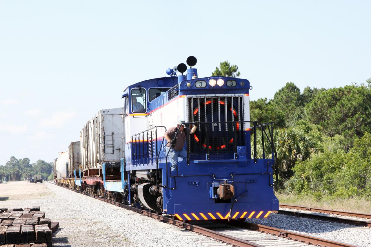 CAPE CANAVERAL, Fla. – Engineers board a NASA Railroad train in preparation for its departure from the NASA Railroad Yard at NASA’s Kennedy Space Center in Florida. The train is headed for the Florida East Coast Railway interchange in Titusville, Fla., where the train’s helium tank cars, a liquid oxygen tank car, and a liquid hydrogen dewar or tank car will be transferred for delivery to the SpaceX engine test complex outside McGregor, Texas.    The railroad cars were needed in support of the Space Shuttle Program but currently are not in use by NASA following the completion of the program in 2011. Originally, the tankers belonged to the U.S. Bureau of Mines.  At the peak of the shuttle program, there were approximately 30 cars in the fleet.  About half the cars were returned to the bureau as launch activity diminished. Five tank cars are being loaned to SpaceX and repurposed to support their engine tests in Texas. Eight cars previously were shipped to California on loan to support the SpaceX Falcon 9 rocket launches from Space Launch Complex-4 on Vandenberg Air Force Base.  SpaceX already has three helium tank cars previously used for the shuttle program at Space Launch Complex-40 on Cape Canaveral Air Force Station in Florida. For more information, visit http://www.nasa.gov/spacex.  Photo credit: NASA/Jim Grossmann