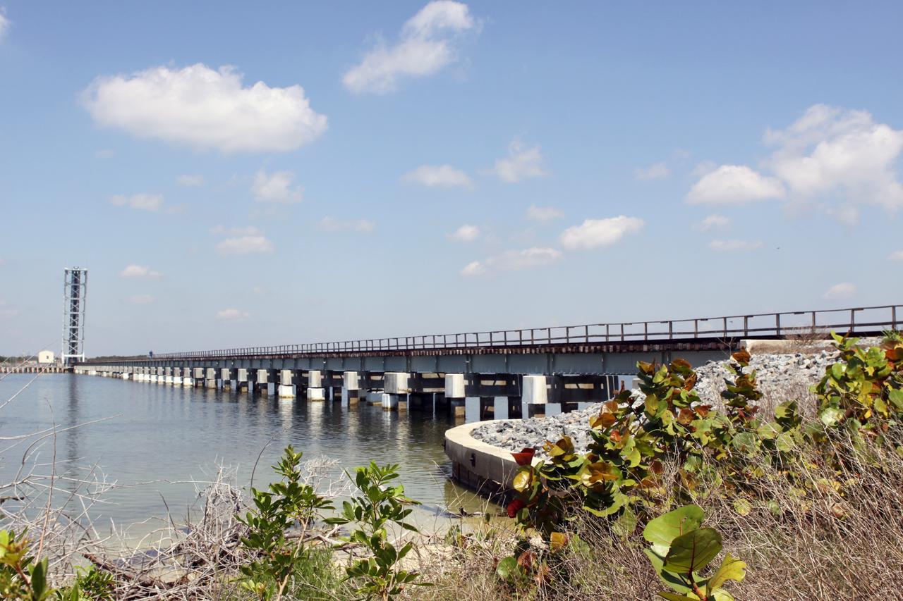 CAPE CANAVERAL, Fla. – Preparations are under way at the NASA Railroad’s Jay Jay Railroad Bridge north of Launch Complex 39 at NASA’s Kennedy Space Center in Florida for the passage of the NASA Railroad train on its way to the Florida East Coast Railway interchange in Titusville, Fla., where the train’s helium tank cars, a liquid oxygen tank car, and a liquid hydrogen dewar or tank car will be transferred for delivery to the SpaceX engine test complex outside McGregor, Texas.  The permanent configuration of the drawbridge span is open, but the span will be lowered for a train to cross.    The railroad cars were needed in support of the Space Shuttle Program but currently are not in use by NASA following the completion of the program in 2011. Originally, the tankers belonged to the U.S. Bureau of Mines.  At the peak of the shuttle program, there were approximately 30 cars in the fleet.  About half the cars were returned to the bureau as launch activity diminished. Five tank cars are being loaned to SpaceX and repurposed to support their engine tests in Texas. Eight cars previously were shipped to California on loan to support the SpaceX Falcon 9 rocket launches from Space Launch Complex-4 on Vandenberg Air Force Base.  SpaceX already has three helium tank cars previously used for the shuttle program at Space Launch Complex-40 on Cape Canaveral Air Force Station in Florida. For more information, visit http://www.nasa.gov/spacex.  Photo credit: NASA/Jim Grossmann