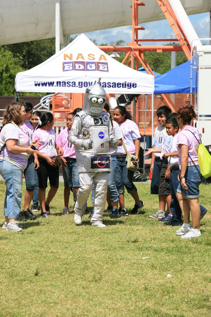 CAPE CANAVERAL, Fla. – A robotic mascot moves among participants during NASA's Lunabotics Mining Competition at the Kennedy Space Center Visitor Complex in Florida. The competition challenges university students to build machines that can collect soil such as the material found on the moon. Working inside the Caterpillar LunArena, the robotic craft dig soil that simulates lunar material. The event is judged by a machine's abilities to collect the soil, its design and operation, size, dust tolerance and its level of autonomy.  Photo credit: NASA/Glenn Benson