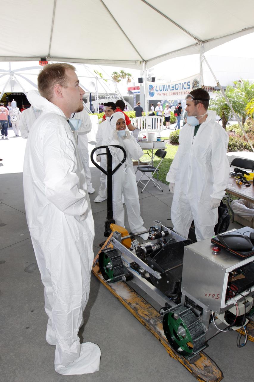 CAPE CANAVERAL, Fla. – A team of competitors waits for a turn in NASA's Lunabotics Mining Competition at the Kennedy Space Center Visitor Complex in Florida. The competition challenges university students to build machines that can collect soil such as the material found on the moon. Working inside the Caterpillar LunArena, the robotic craft dig soil that simulates lunar material. The event is judged by a machine's abilities to collect the soil, its design and operation, size, dust tolerance and its level of autonomy. Photo credit: NASA/Glenn Benson