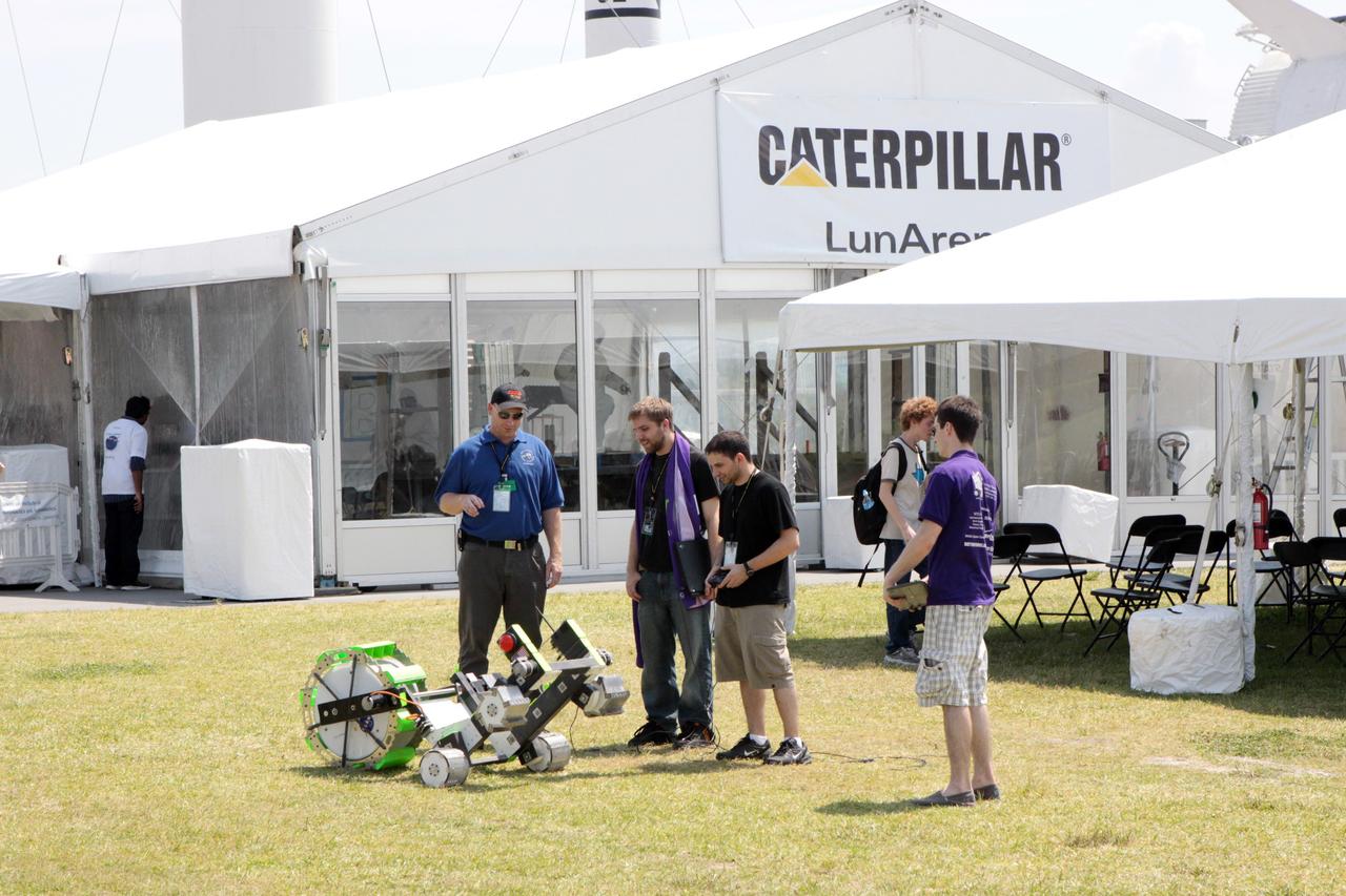 CAPE CANAVERAL, Fla. – A team of competitors readies its robotic vehicle taking part in the racing portion of NASA's Lunabotics Mining Competition at the Kennedy Space Center Visitor Complex in Florida. Although much of the competition was based on a vehicle's ability to dig soil, the festivities also included head-to-head runs for the robotic craft. Photo credit: NASA/Jim Grossmann