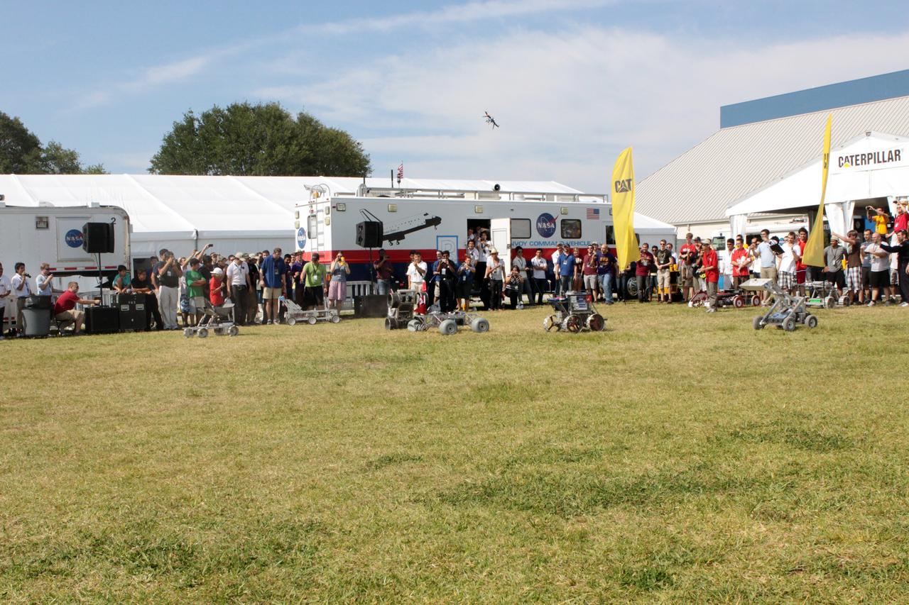 CAPE CANAVERAL, Fla. – Robotic vehicles take part in the racing portion of NASA's Lunabotics Mining Competition at the Kennedy Space Center Visitor Complex in Florida. Although much of the competition was based on a vehicle's ability to dig soil, the festivities also included head-to-head runs for the robotic craft. Photo credit: NASA/Jim Grossmann