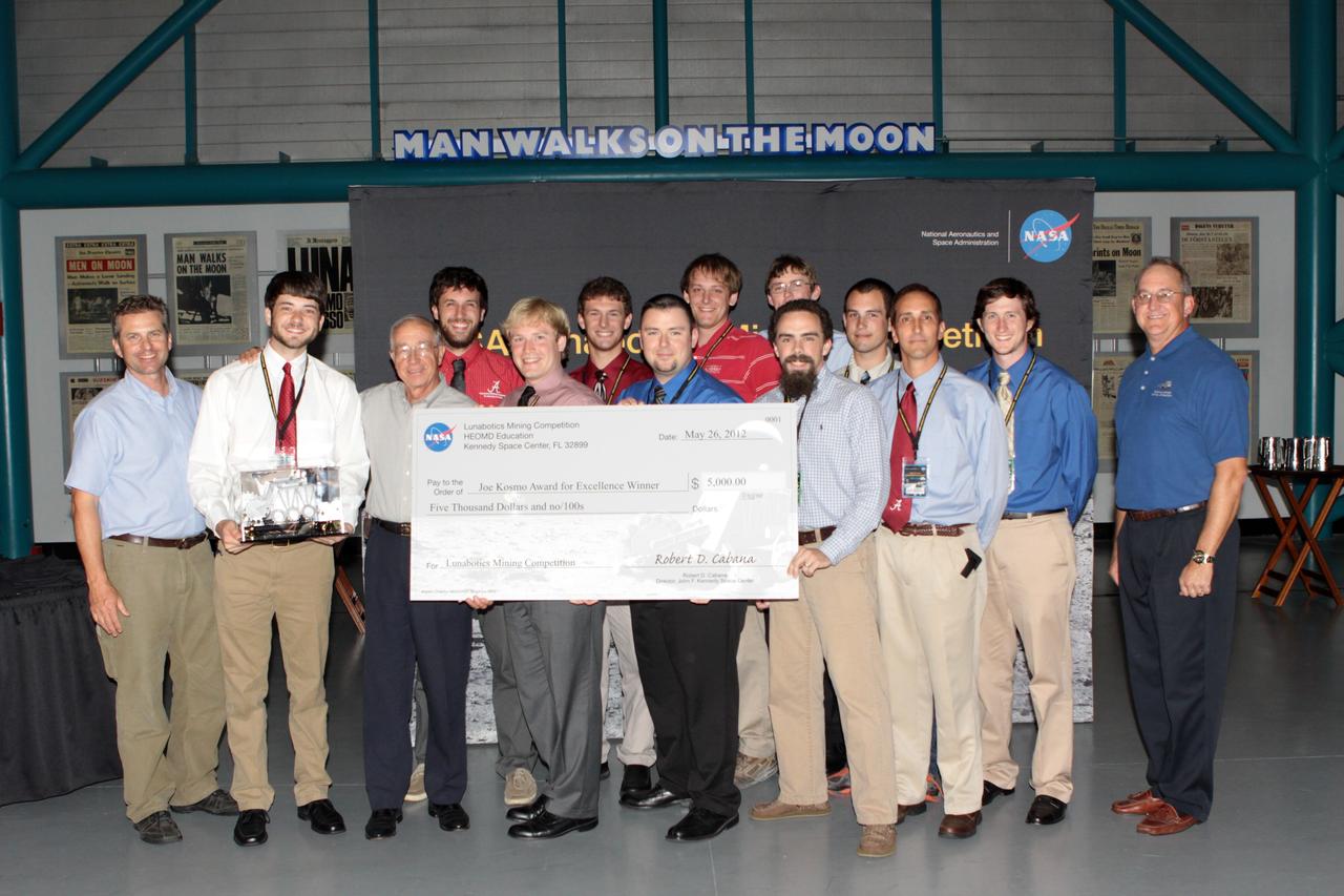 CAPE CANAVERAL, Fla. – The team from the University of Alabama team took home the Joe Kosmo Award for Excellence for designing and operating the winning robotic vehicle during NASA's Lunabotics Mining Competition. The competition challenged university students to build machines that could collect soil such as the material found on the moon. Working inside the Caterpillar LunArena, the robotic craft dug soil that simulated lunar material. The event was judged by a machine's abilities to collect the soil, its design and operation, size, dust tolerance and its level of autonomy. Photo credit: NASA/Jim Grossmann