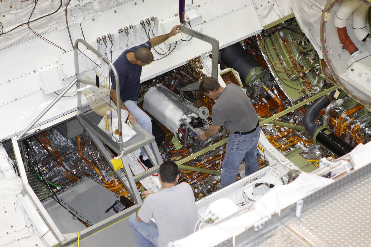 CAPE CANAVERAL, Fla. – Inside Orbiter Processing Facility-2 at NASA's Kennedy Space Center in Florida, technicians use a special crane to lift a fuel cell out of space shuttle Endeavour's payload bay.    All three of Endeavour's fuel cells were removed and will be drained of fluids. The hydrogen and oxygen dewars which feed reactants to the fuel cells remain in Endeavour's midbody and will be purged with inert gases and vented down. The work is part of the Space Shuttle Program's transition and retirement processing of shuttle Endeavour, which is being prepared for public display at the California Science Center in Los Angeles. Its ferry flight to California is targeted for mid-September. Endeavour was the last space shuttle added to NASA's orbiter fleet. Over the course of its 19-year career, Endeavour spent 299 days in space during 25 missions. For more information, visit http://www.nasa.gov/shuttle. Photo credit: NASA/Glenn Benson