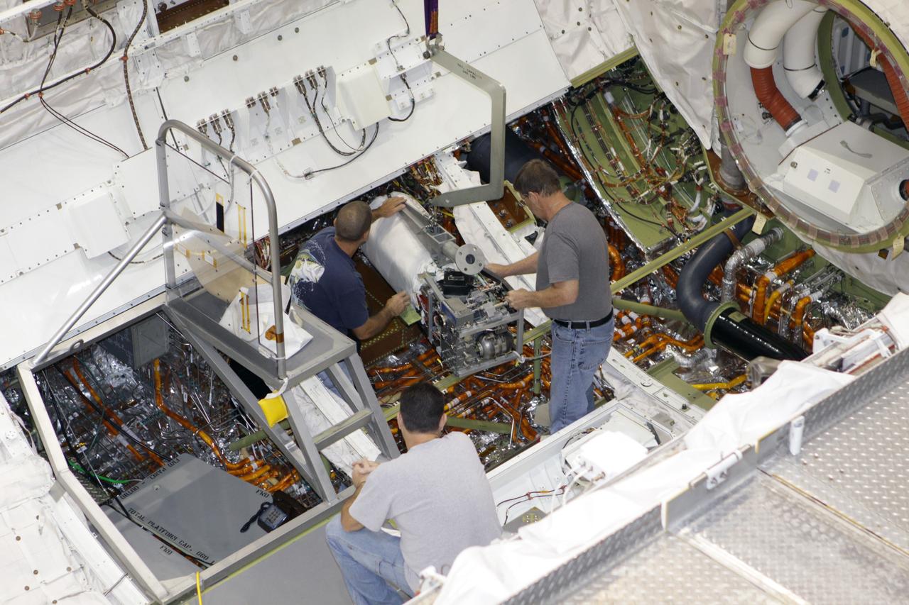 CAPE CANAVERAL, Fla. – Inside Orbiter Processing Facility-2 at NASA's Kennedy Space Center in Florida, technicians use a special crane to lift a fuel cell out of space shuttle Endeavour's payload bay.    All three of Endeavour's fuel cells were removed and will be drained of fluids. The hydrogen and oxygen dewars which feed reactants to the fuel cells remain in Endeavour's midbody and will be purged with inert gases and vented down. The work is part of the Space Shuttle Program's transition and retirement processing of shuttle Endeavour, which is being prepared for public display at the California Science Center in Los Angeles. Its ferry flight to California is targeted for mid-September. Endeavour was the last space shuttle added to NASA's orbiter fleet. Over the course of its 19-year career, Endeavour spent 299 days in space during 25 missions. For more information, visit http://www.nasa.gov/shuttle. Photo credit: NASA/Glenn Benson