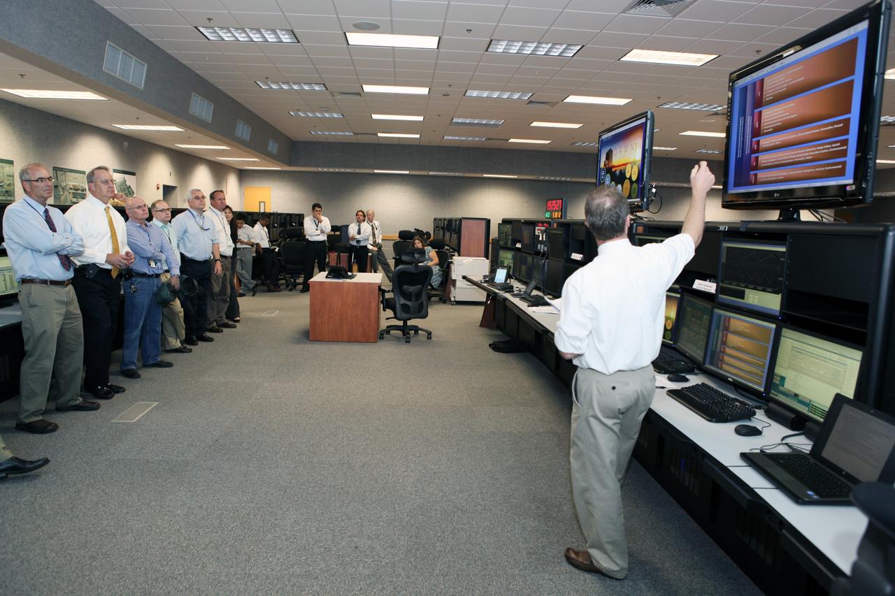 CAPE CANAVERAL, Fla. – Workers at NASA's Kennedy Space Center watch a demonstration of new systems installed in the Young-Crippen Firing Room, also known as Firing Room 1, inside the Launch Control Center. The renovation has been led by the Ground Systems Development and Operations Program based at Kennedy. The new systems are designed to be flexible so controllers can process and launch multiple types of rockets and spacecraft, whether they are government or commercial models. Photo credit: NASA/Dmitri Gerondidakis