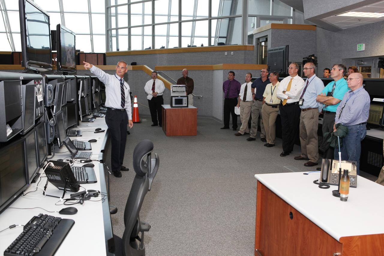 CAPE CANAVERAL, Fla. – Workers at NASA's Kennedy Space Center watch a demonstration of new systems installed in the Young-Crippen Firing Room, also known as Firing Room 1, inside the Launch Control Center. The renovation has been led by the Ground Systems Development and Operations Program based at Kennedy. The new systems are designed to be flexible so controllers can process and launch multiple types of rockets and spacecraft, whether they are government or commercial models. Photo credit: NASA/Dmitri Gerondidakis