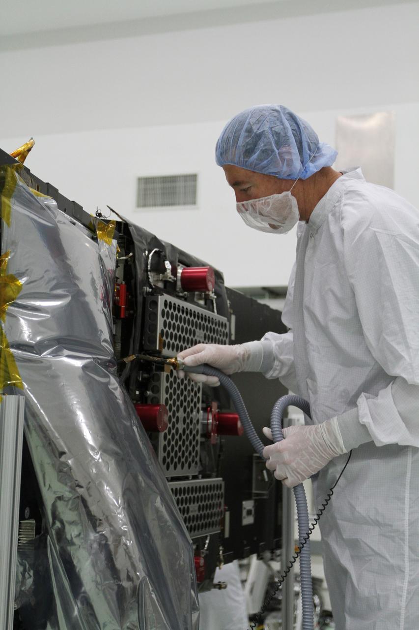 CAPE CANAVERAL, Fla. – A technician cleans and inspects one of NASA's twin Radiation Belt Storm Probes in the clean room high bay at the Astrotech payload processing facility near Kennedy Space Center in Florida. The Radiation Belt Storm Probes, or RBSP, mission will help us understand the sun’s influence on Earth and near-Earth space by studying the Earth’s radiation belts on various scales of space and time. RBSP will begin its mission of exploration of Earth's Van Allen radiation belts and the extremes of space weather after its launch aboard a United Launch Alliance Atlas V rocket. For more information, visit http://www.nasa.gov/rbsp. Photo credit: NASA/Kim Shiflett